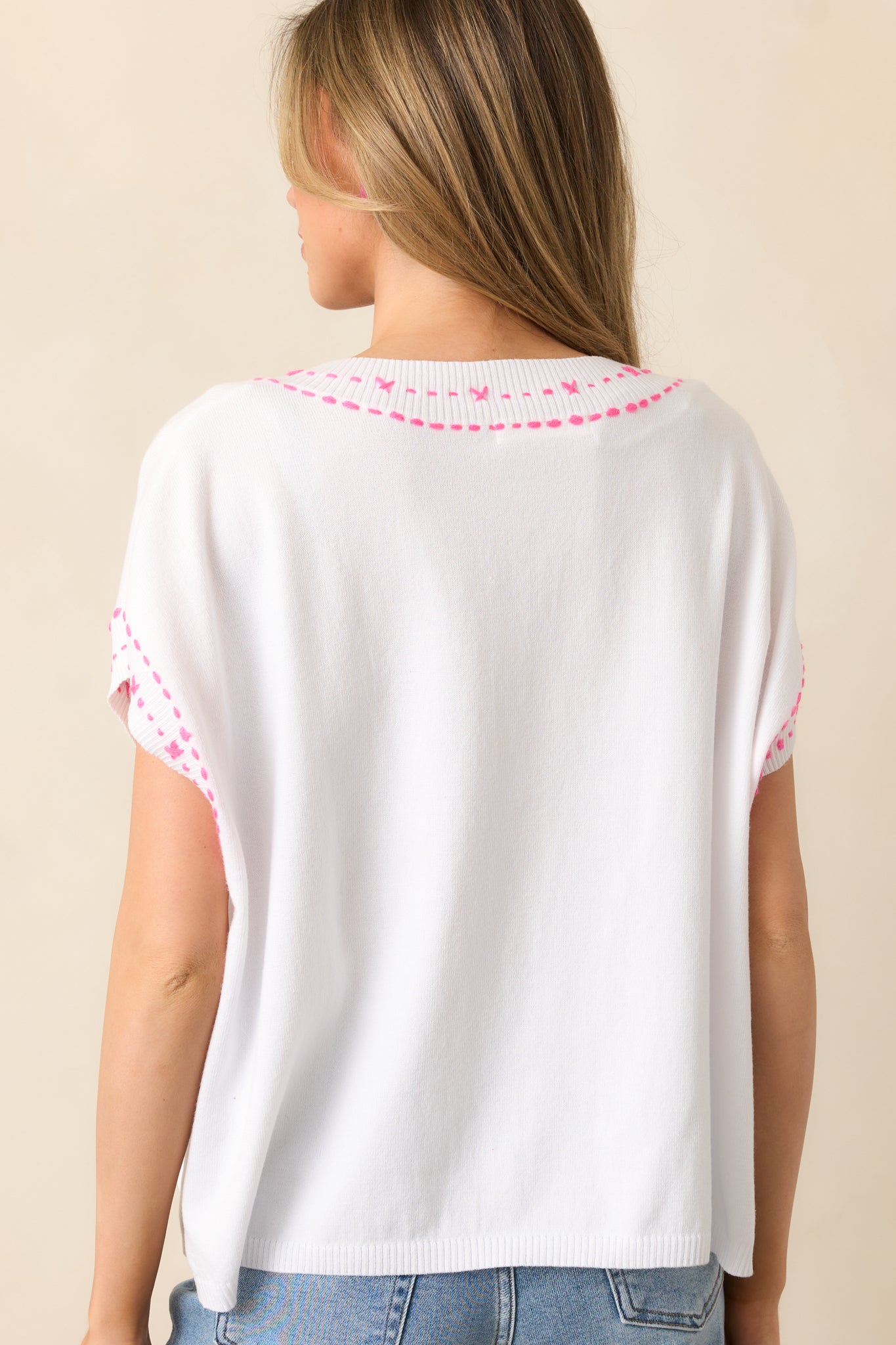 White top shown from behind, emphasizing the relaxed fit, batwing sleeves, and smooth drape of the fabric.