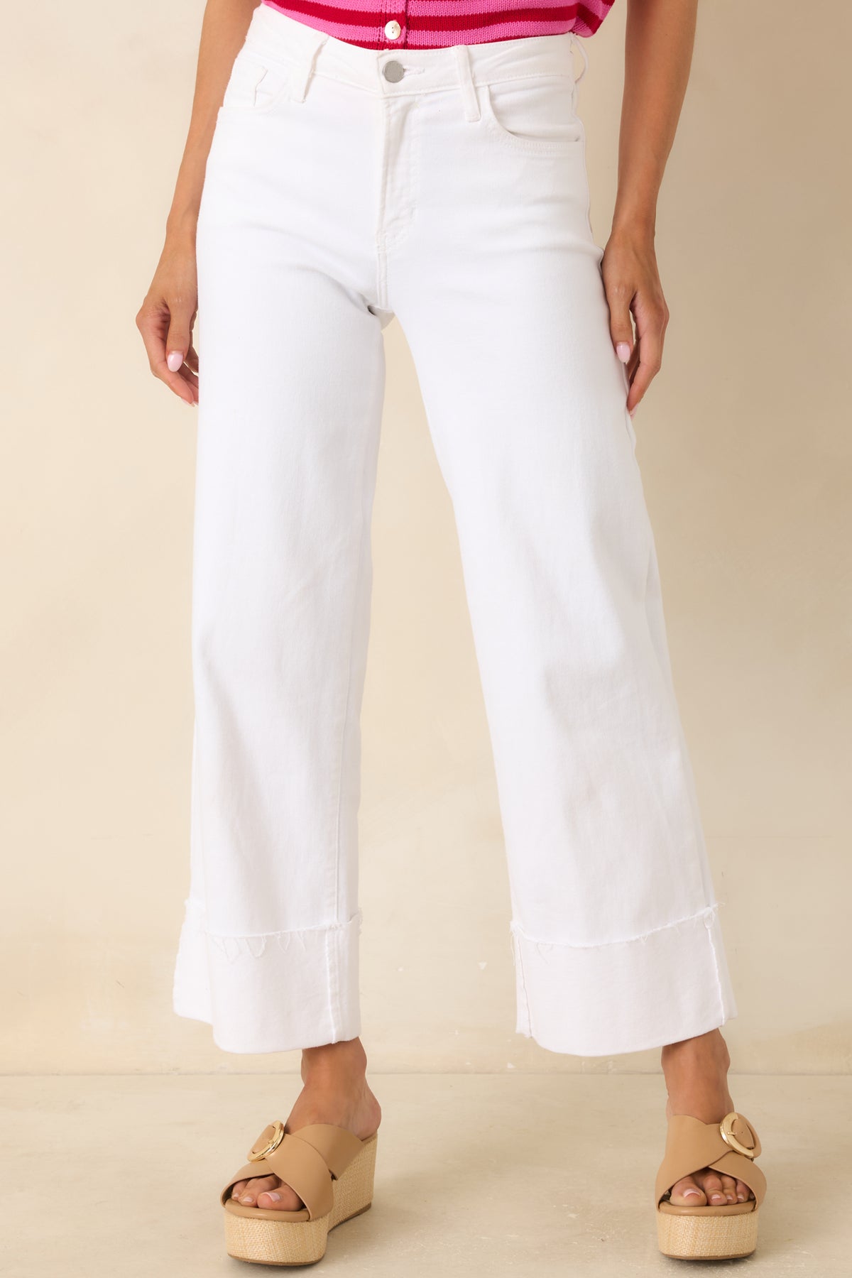 Wide-leg white jeans showcasing the clean denim finish, zipper closure, and structured waist design.