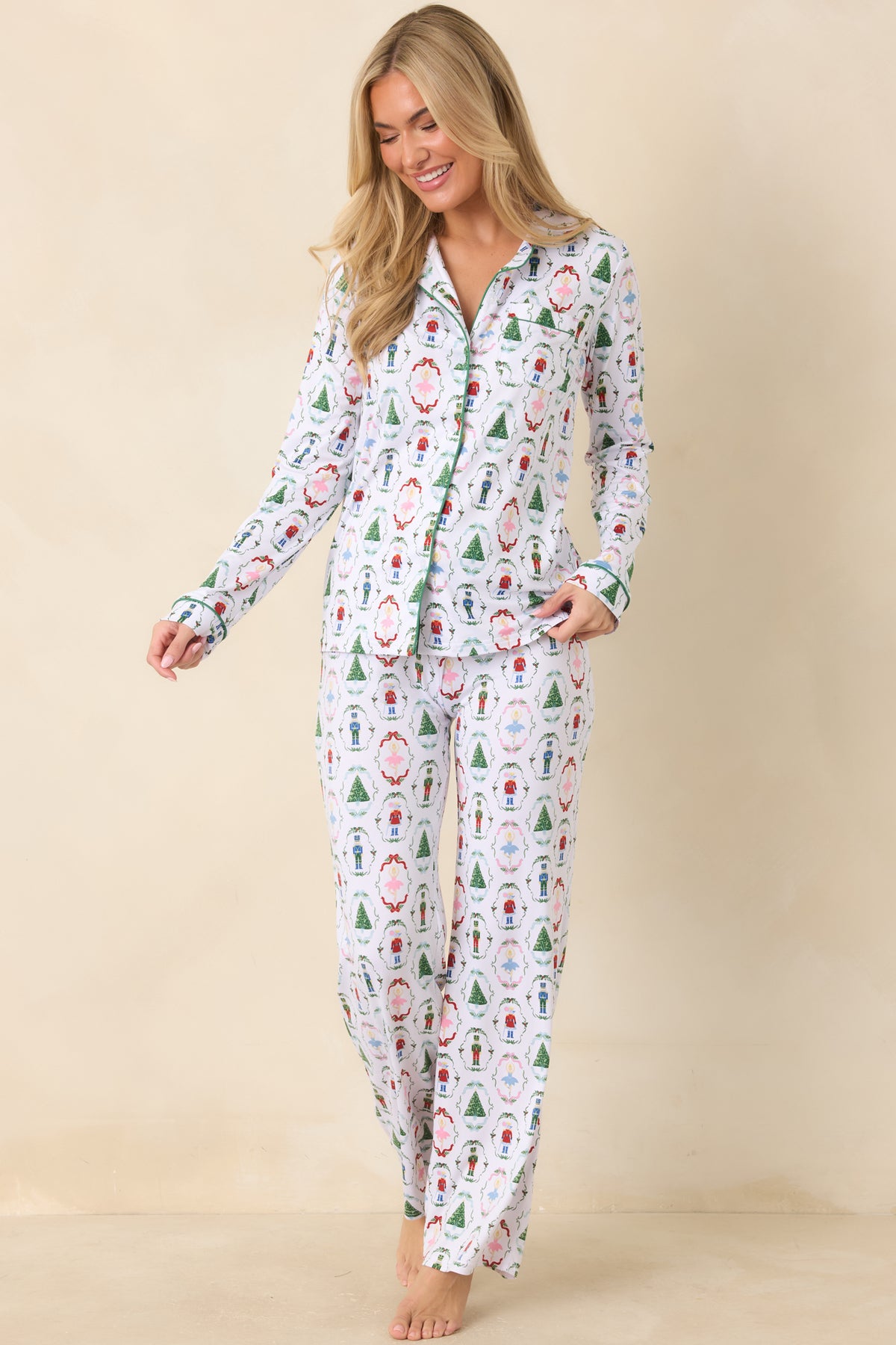 White pajama pants combine a wide-leg silhouette with an allover nutcracker and holiday motif design.
