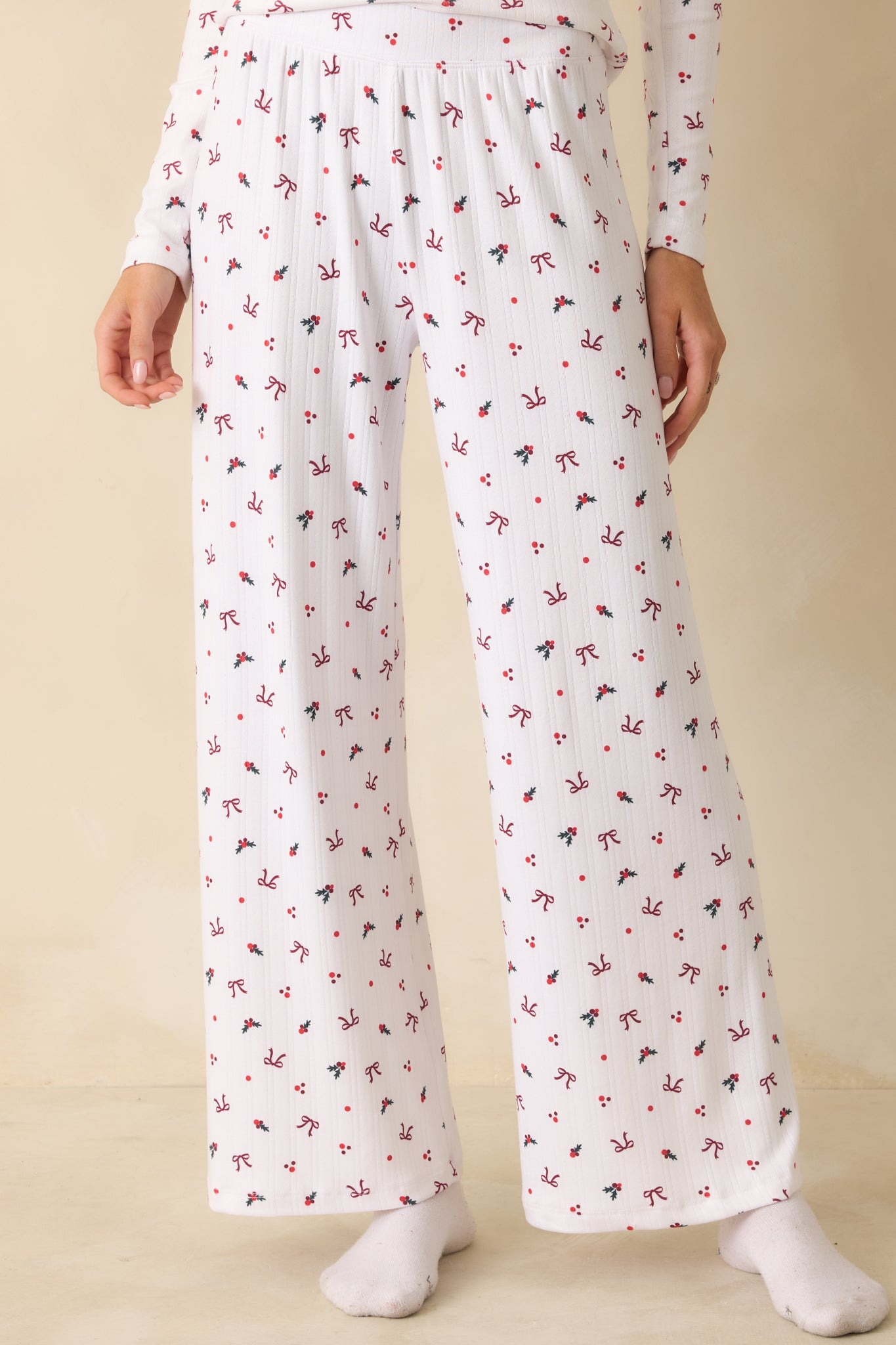 White wide-leg pants cropped at mid-leg, showing the flowy fabric and detailed holiday print