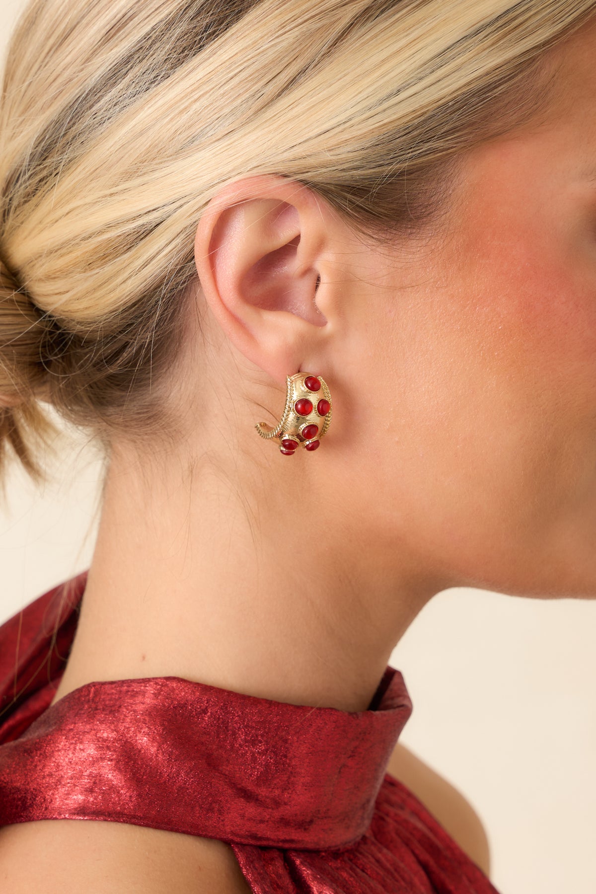 Wide gold hoop earrings accented with polished red bezel-set stones and delicate beaded edges.