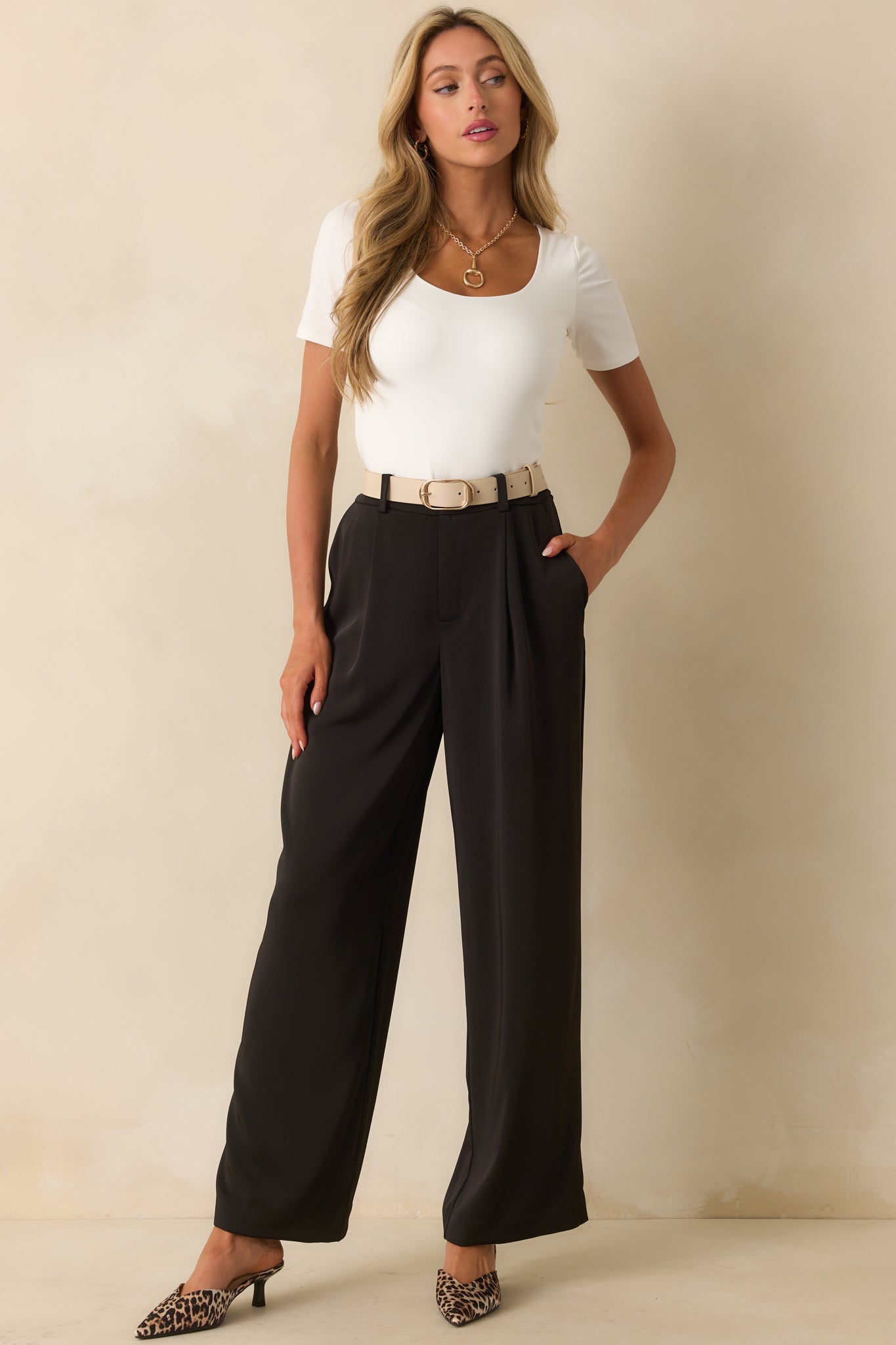Wide-leg black pants featuring belt loops, a hidden hook closure, and a smooth front zip fly.