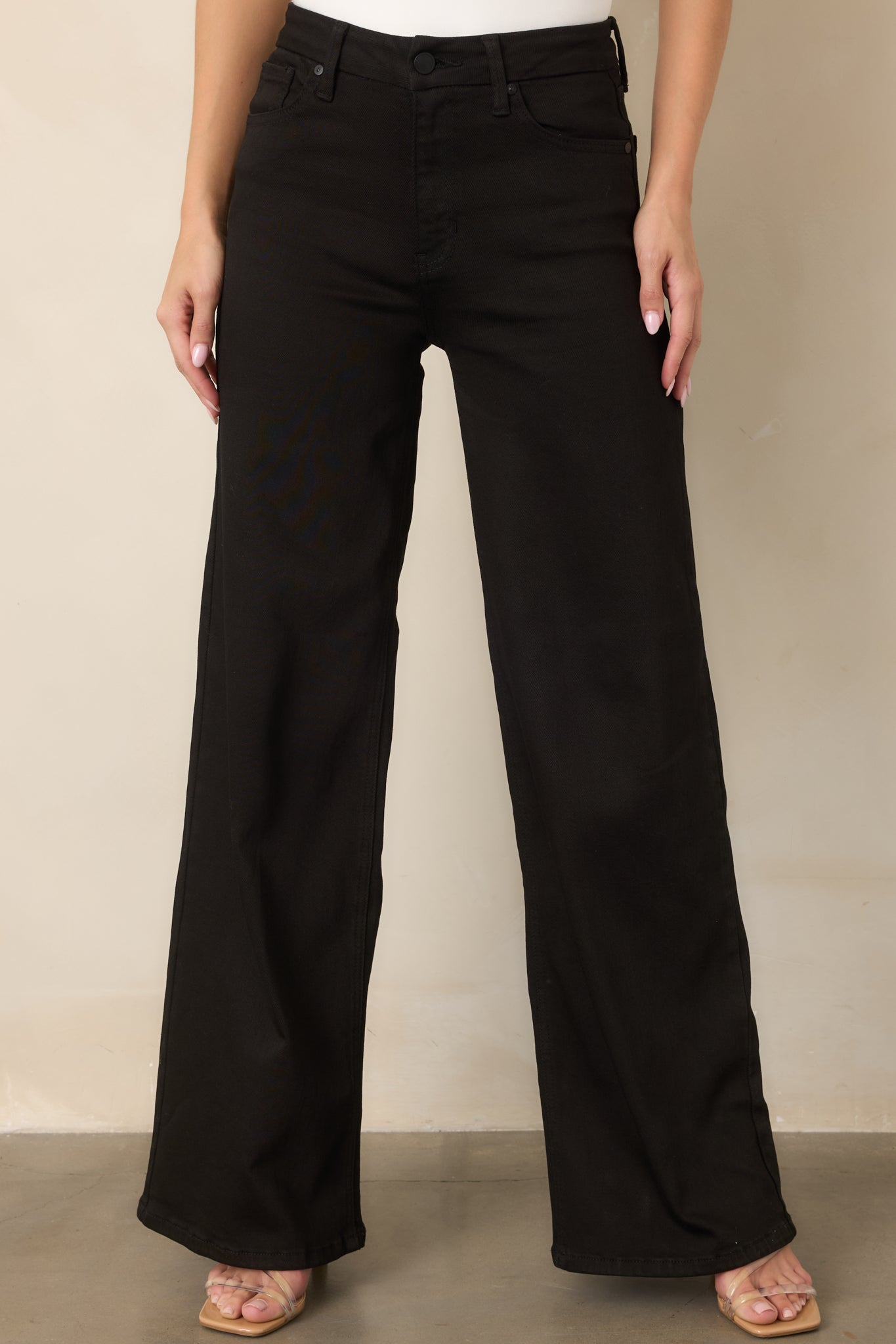 Close view of the front pocket styling and full-cut denim leg, showcasing the structured shape and clean stitching.