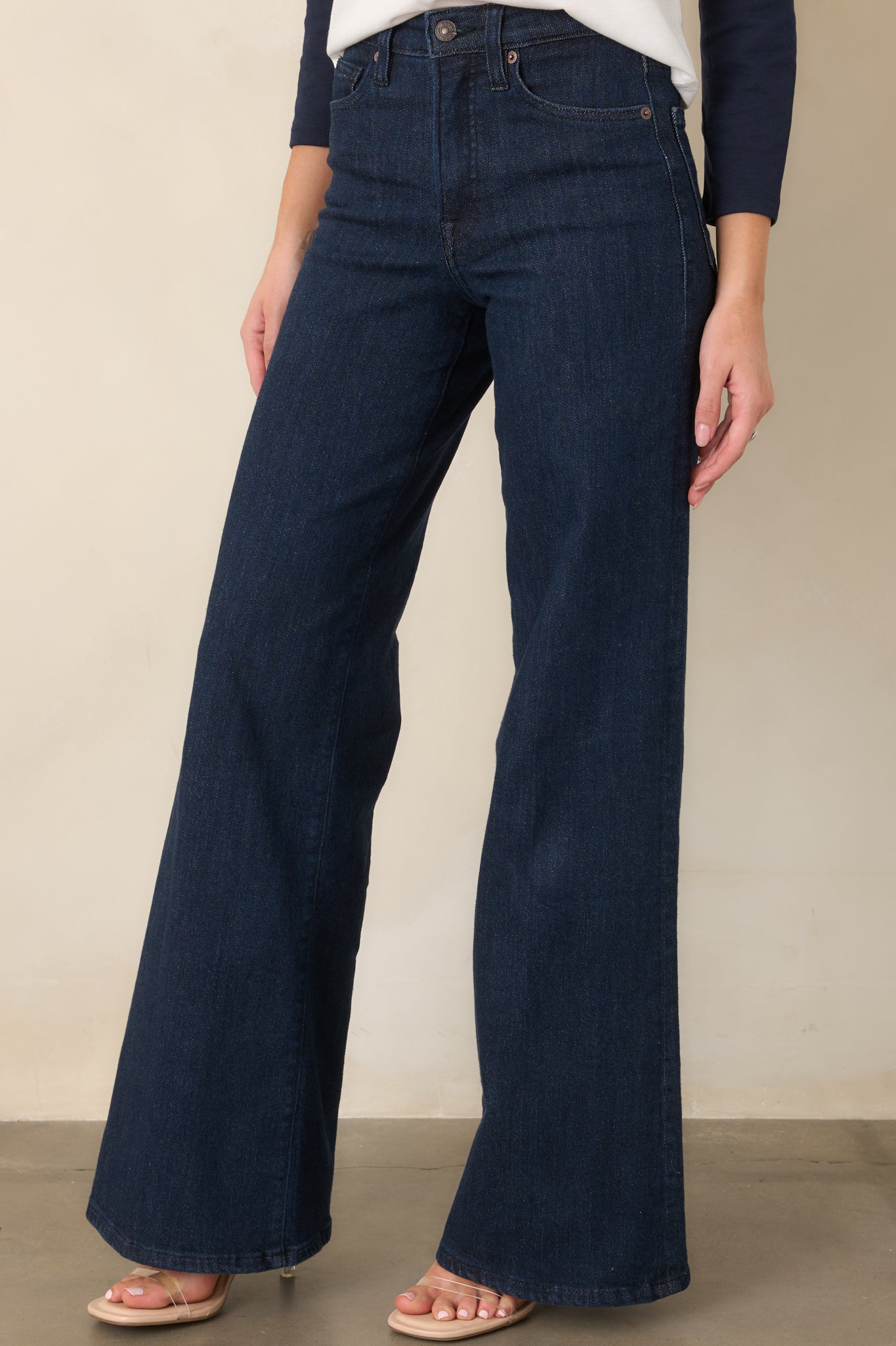 Front view emphasizing the elongated leg line and relaxed width of the wide-leg denim silhouette.
