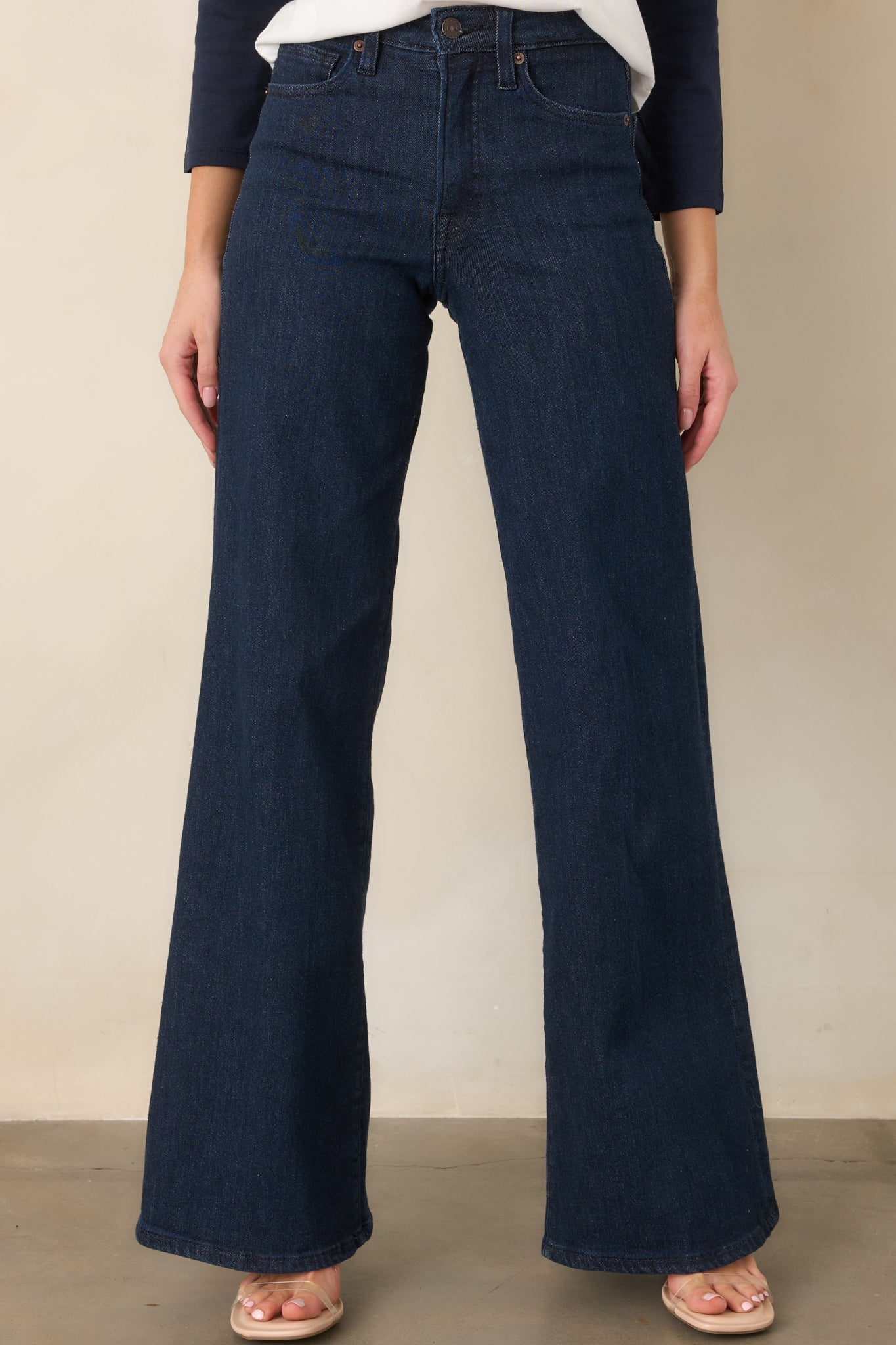 Detailed view of the denim showcasing the front pockets, structured waistband, and relaxed wide-leg fit.