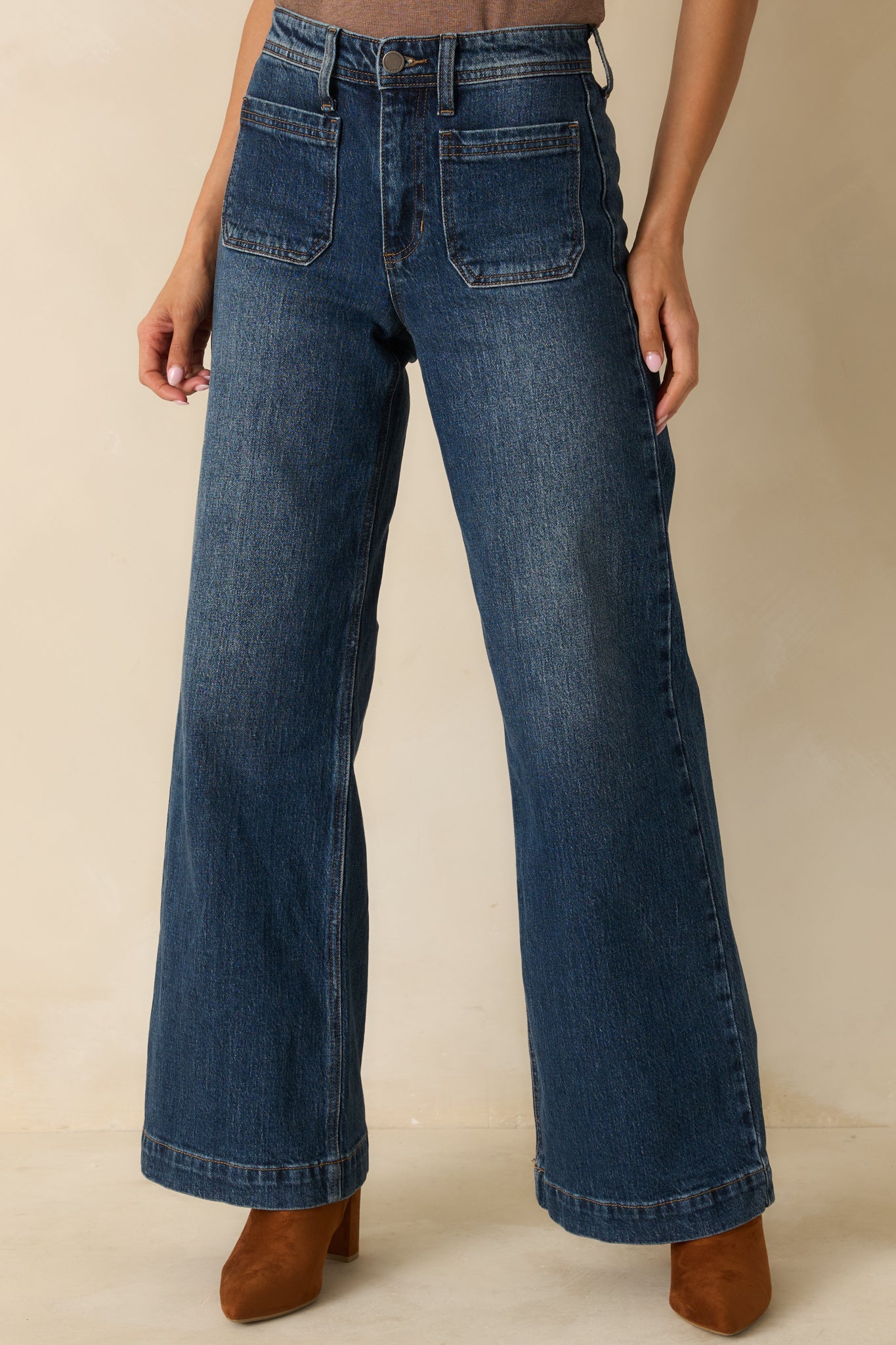 Focus on the wide-leg cut and subtle faded wash of the jeans’ front.