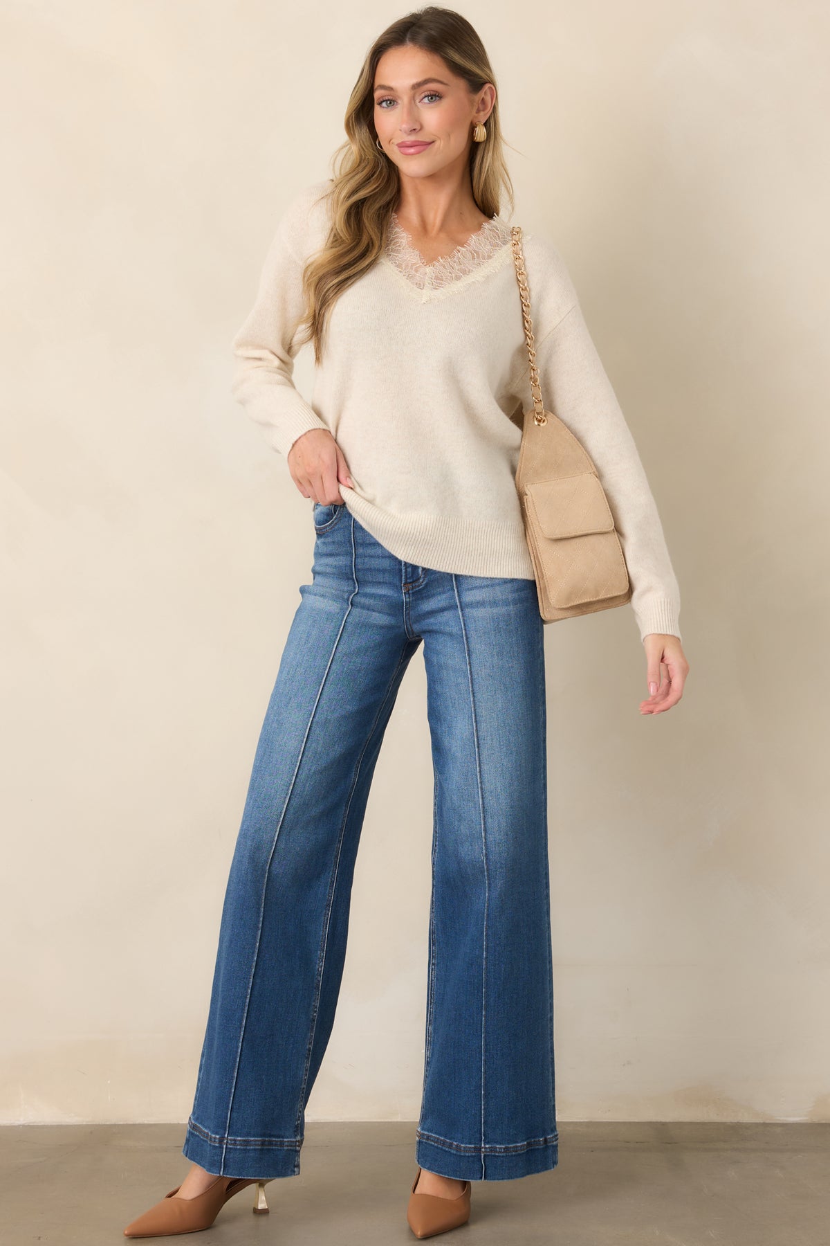 Wide-leg jeans showcasing pintuck seams and long tailored lines.