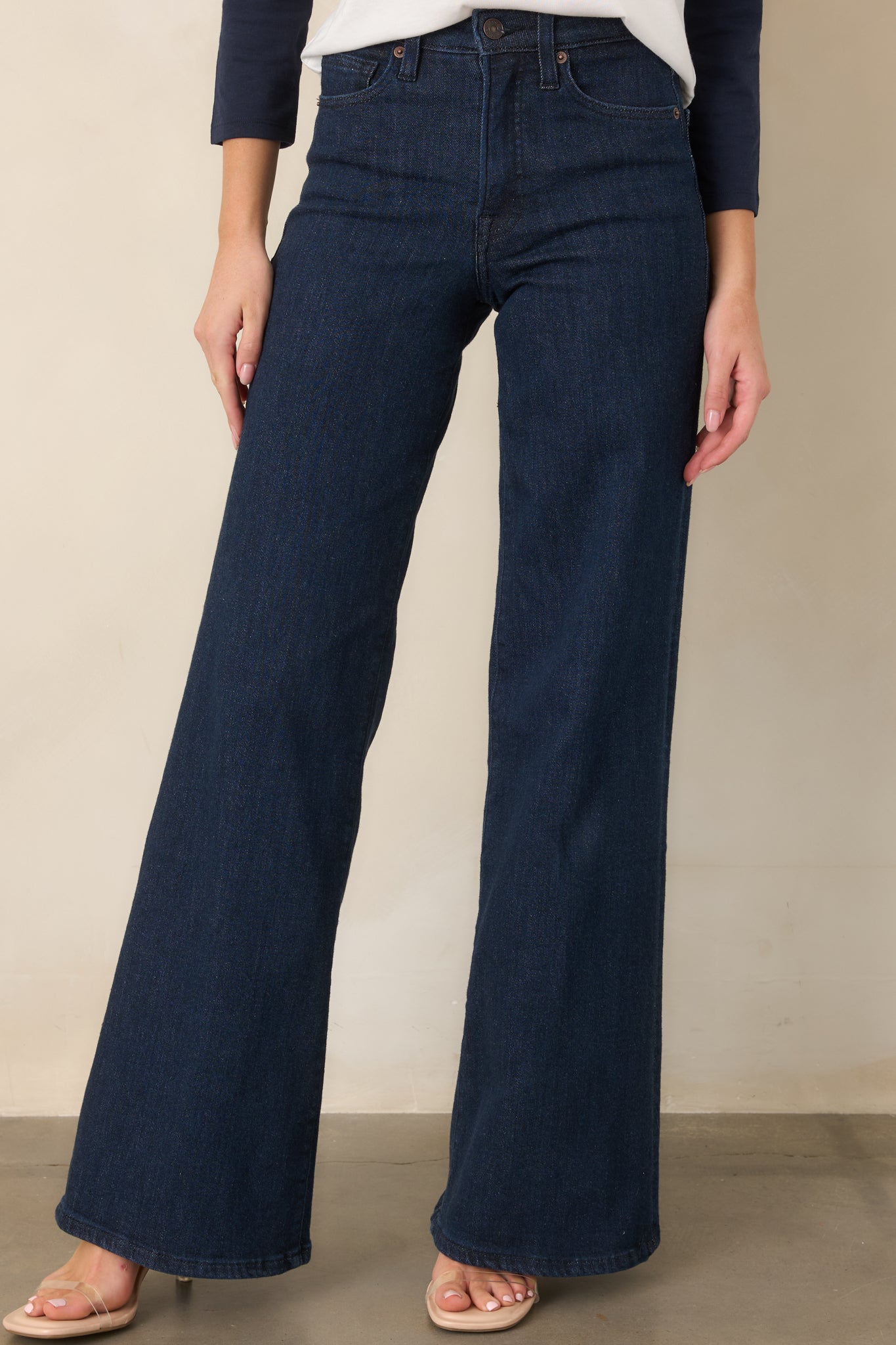 Front detail of the wide-leg jeans highlighting the belt loops, button-and-zip fly, and clean waistband construction.