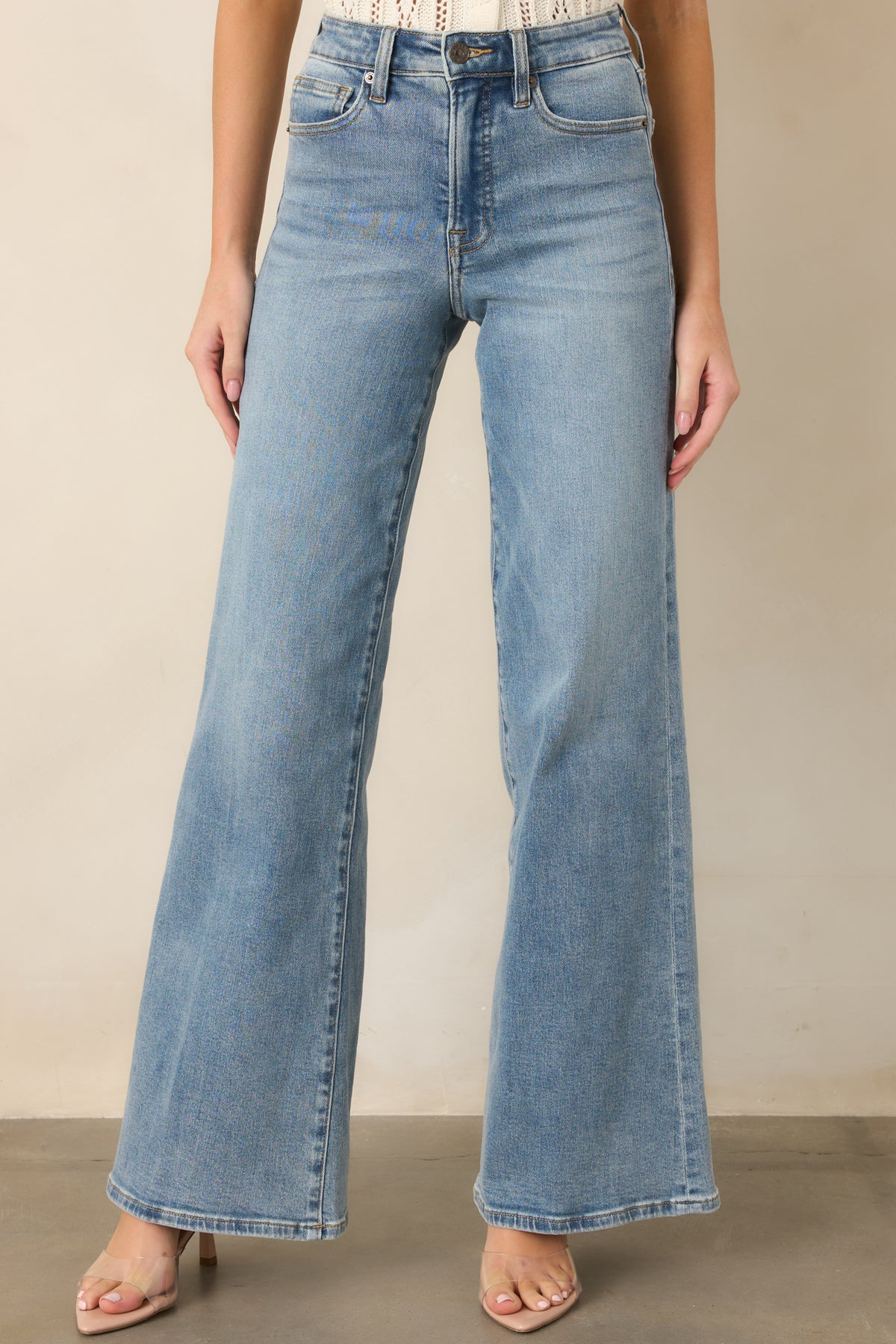 Wide-leg light wash pants featuring a relaxed fit through the legs.