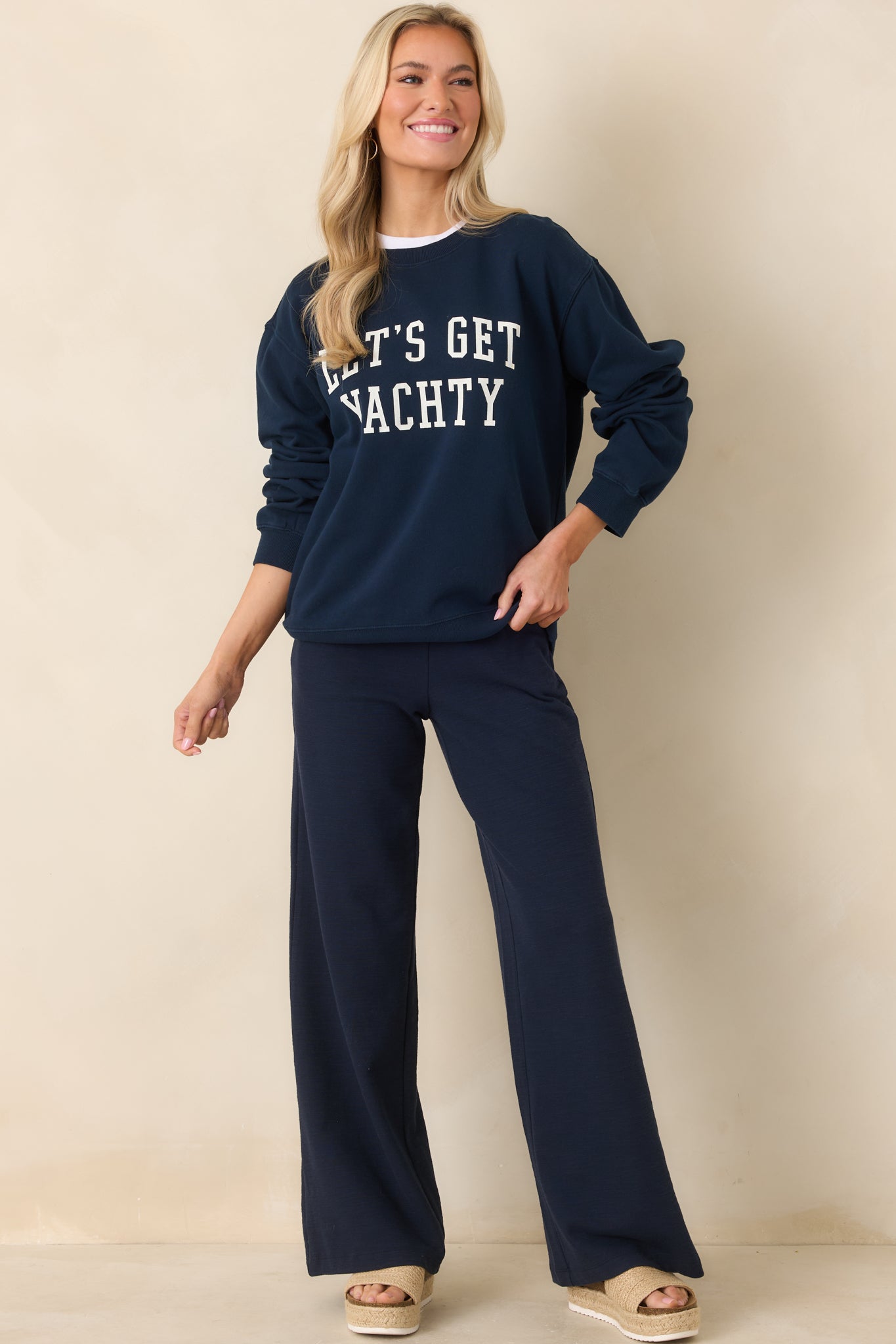 Navy blue wide-leg pants with a high-rise elastic waistband and relaxed full-length silhouette.