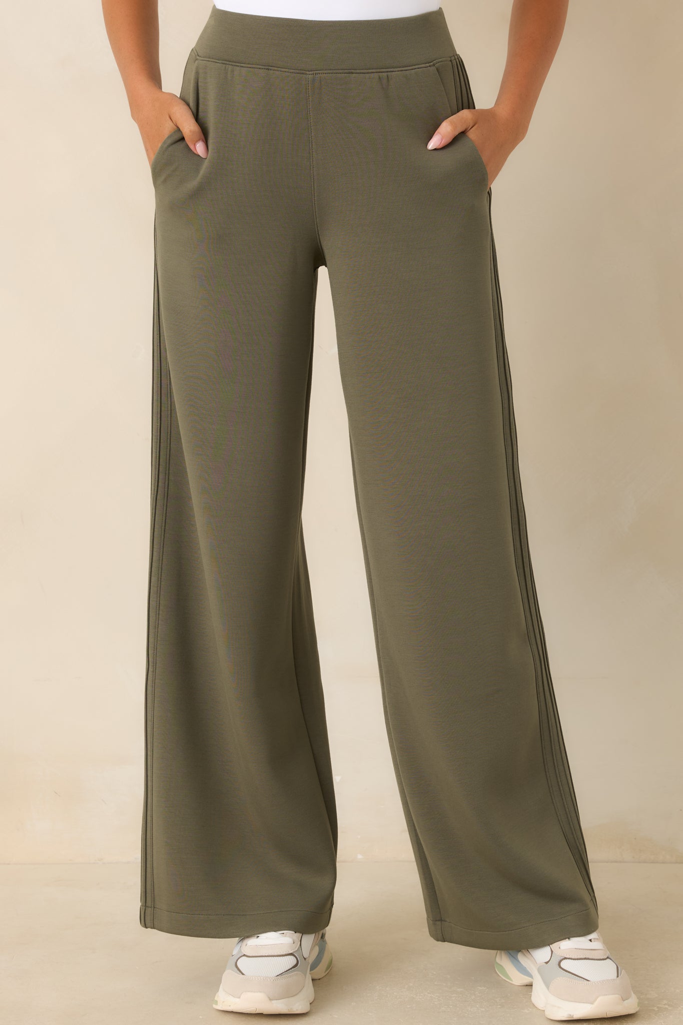 Detailed view of the wide-leg pants featuring raised pintuck outer seams, lightweight stretch fabric, and polished styling.