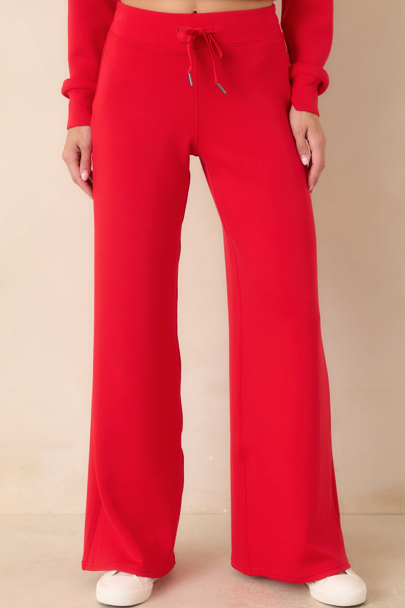 Detailed view of the wide-leg pants featuring clean seam construction, relaxed fit, and fluid drape.