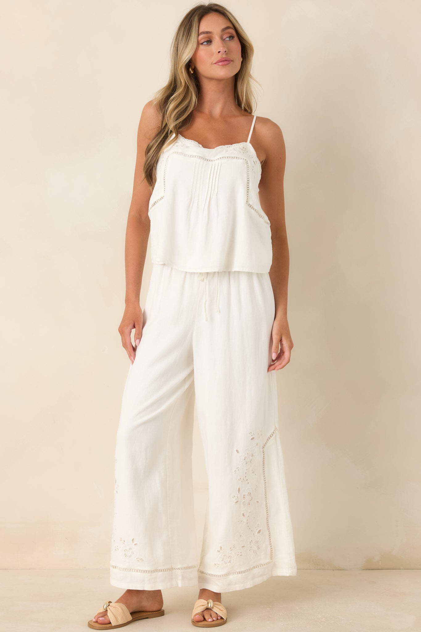 Breathable pants with an adjustable drawstring waist, openwork trim, and a flowing wide leg shape.