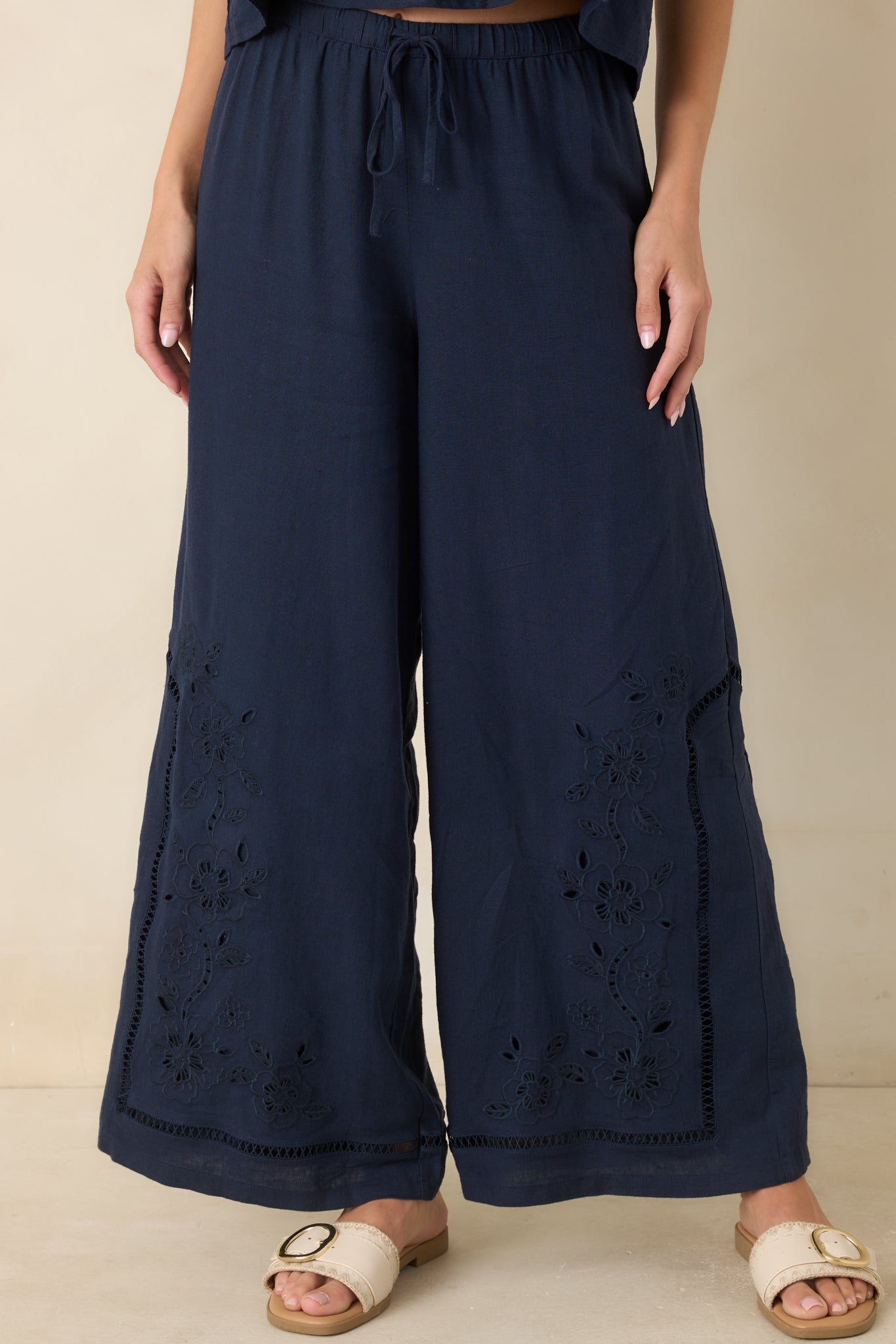 Floral embroidery frames the lower legs of these wide leg pants with openwork detailing.