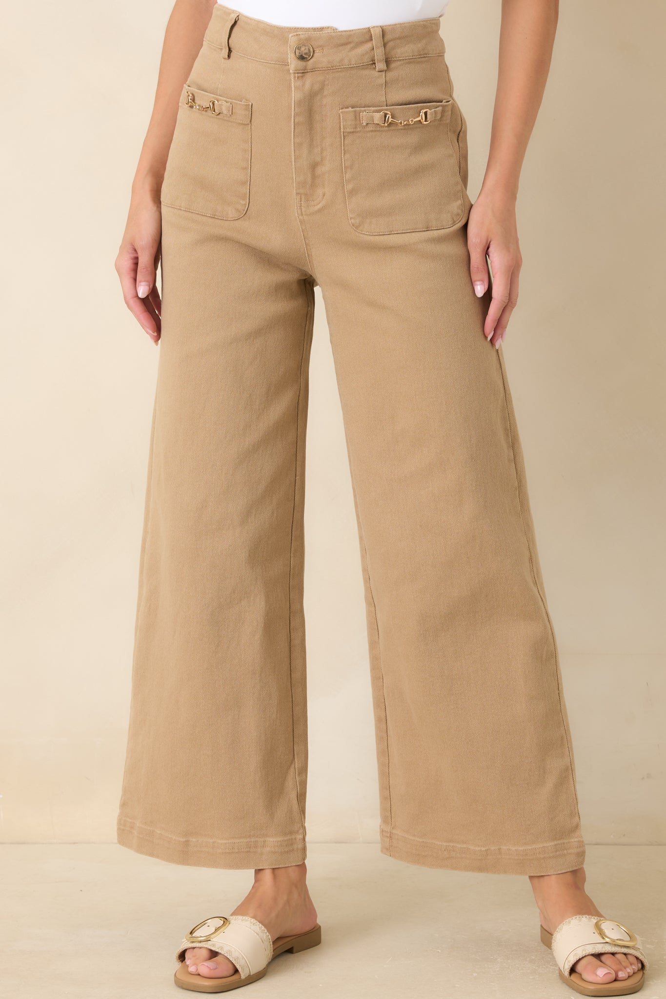 Close view of the wide leg pants highlighting the oversized front patch pockets and polished horsebit detailing.