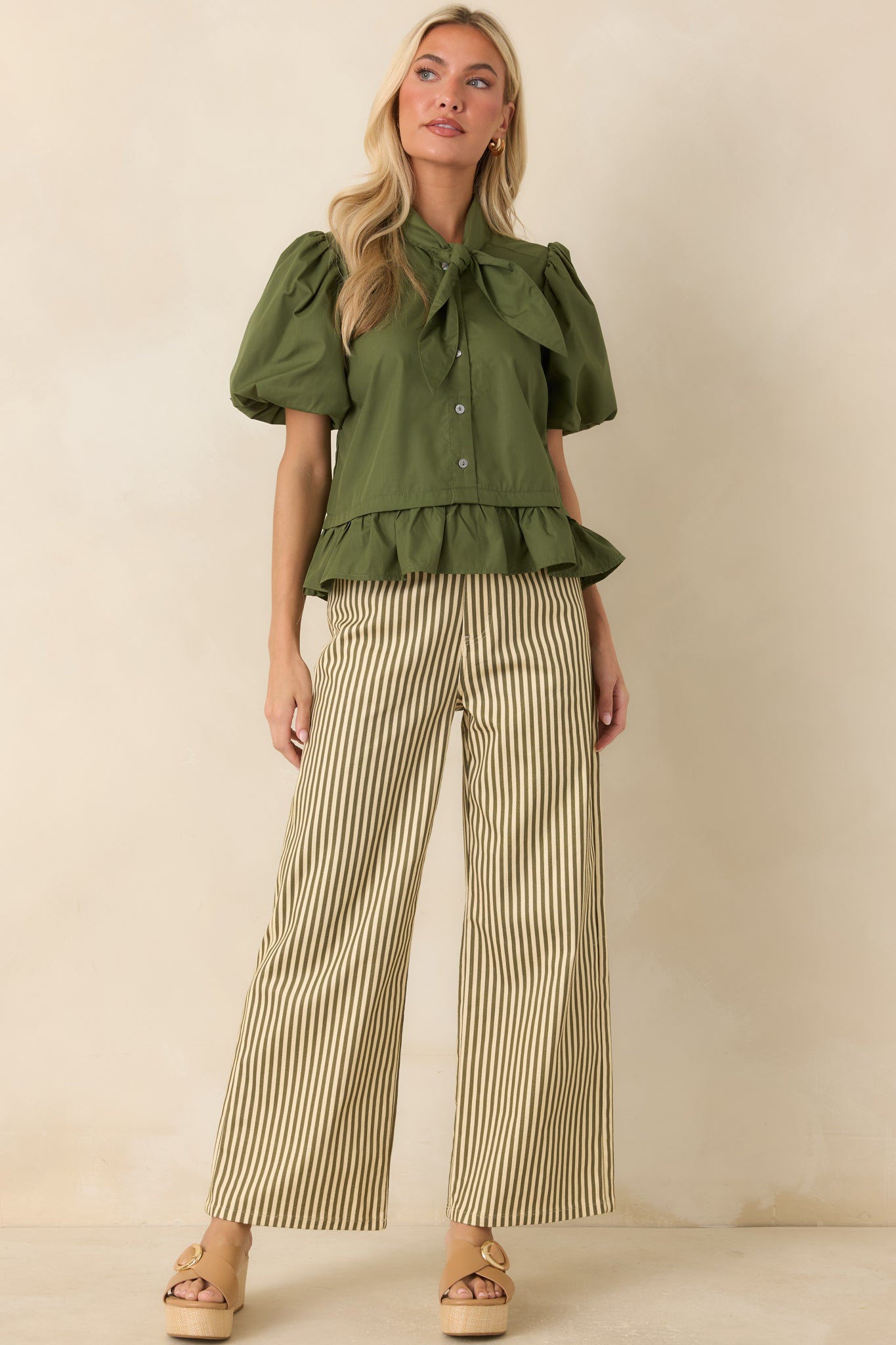 Wide-leg striped pants with a zip fly, button closure, functional pockets, and a polished tailored finish.