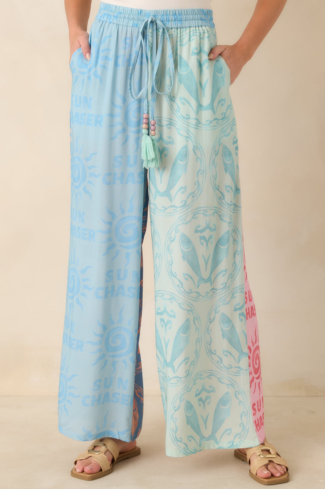 Wide leg viscose pants featuring a relaxed fit, adjustable drawstring, and eye-catching printed design.