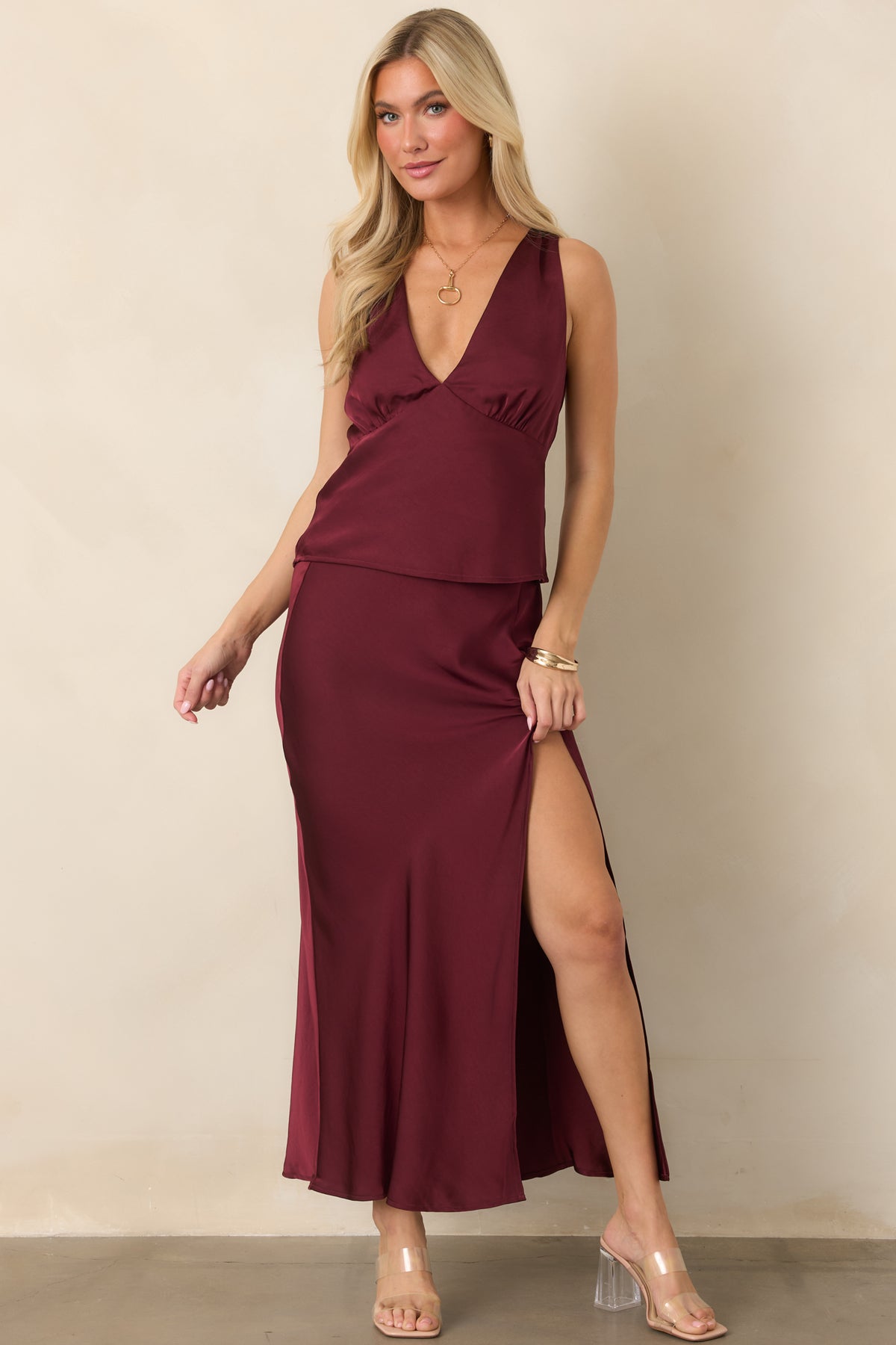 Bias-cut midi skirt in rich wine satin with a side slit and gently flared hem.