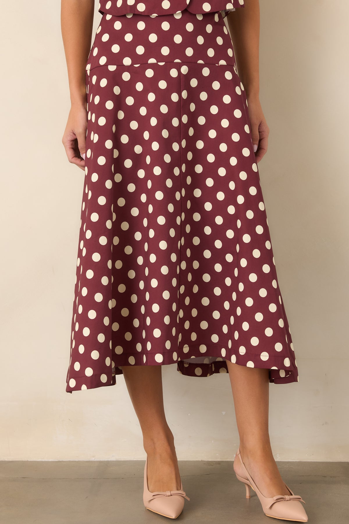 Wine and ivory cotton skirt with a fitted upper section and gently flowing flare.