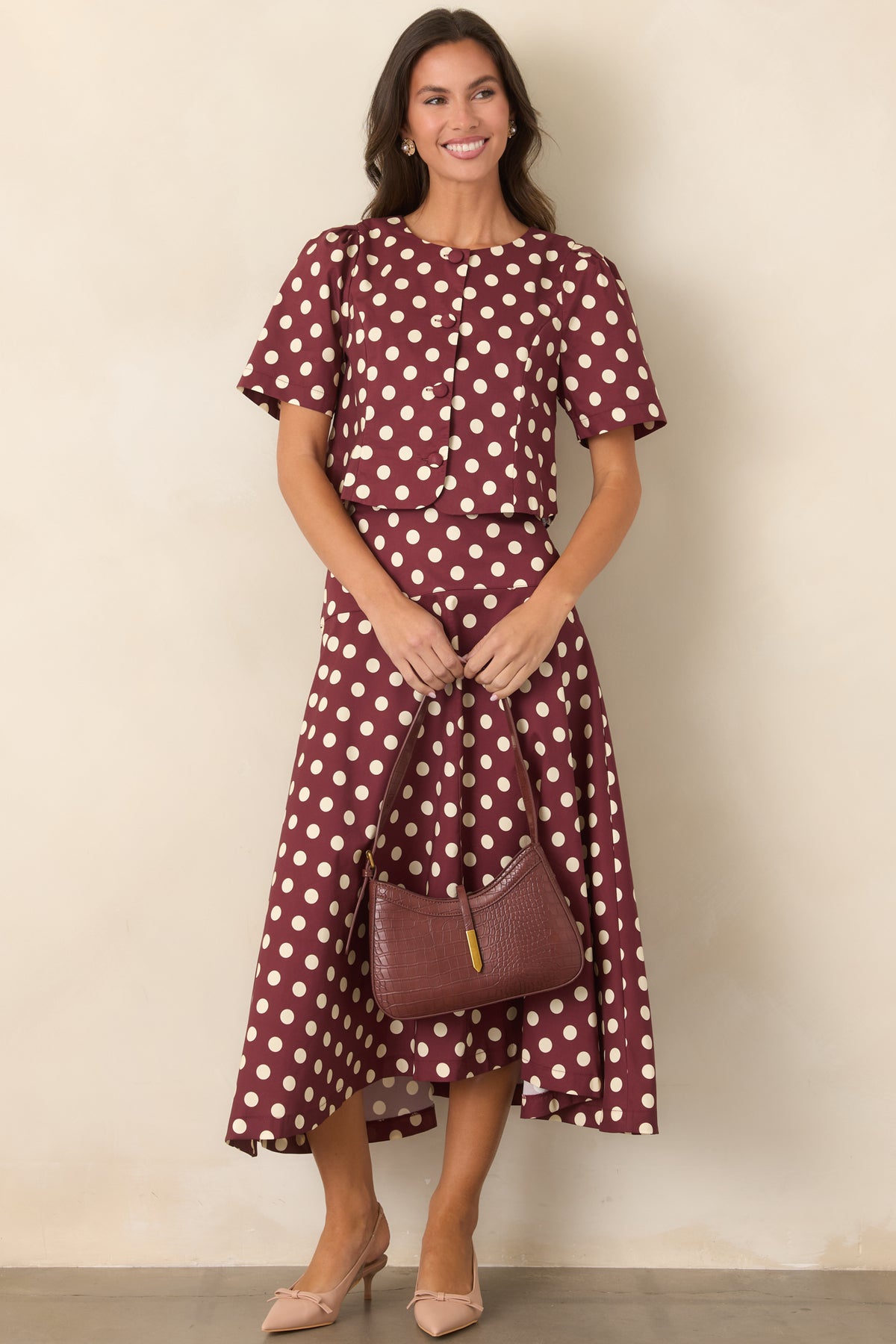 Ivory polka dot cropped top in rich wine cotton with a round neckline and short gathered sleeves.