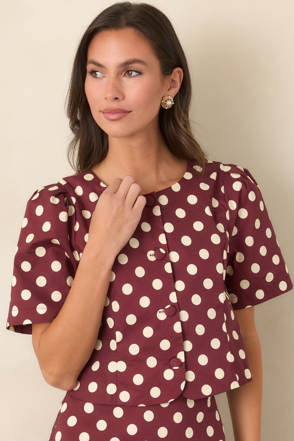 Wine and ivory polka dot top featuring shaping seams through the tailored bodice.