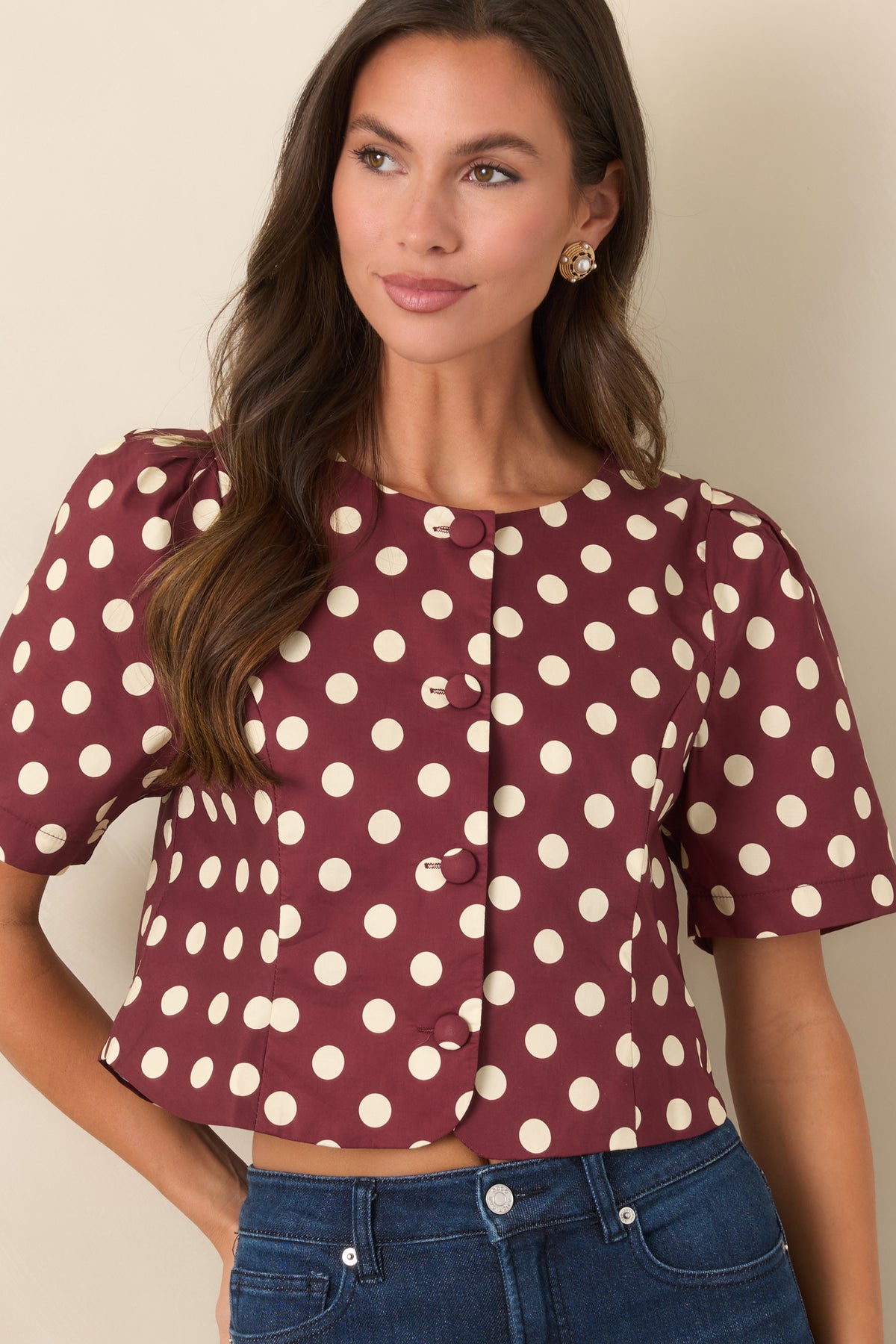 Ivory polka dot pattern on a wine cropped top with a tailored silhouette and curved front hem.