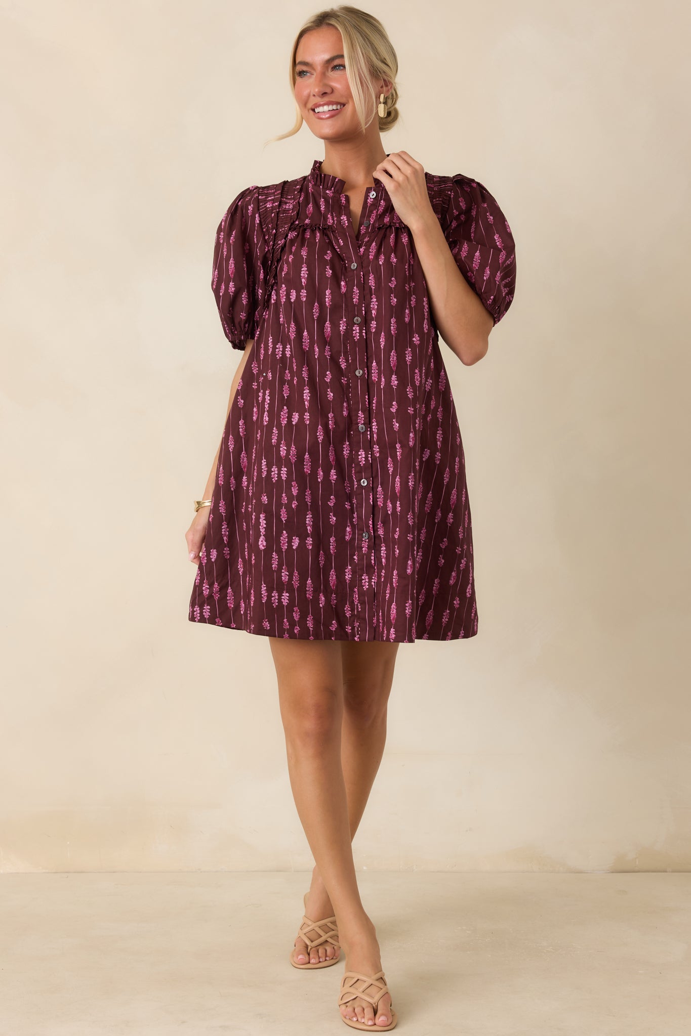 Wine mini dress featuring a vertical pink abstract stripe print, ruffled split neckline, puff sleeves, and a relaxed silhouette.