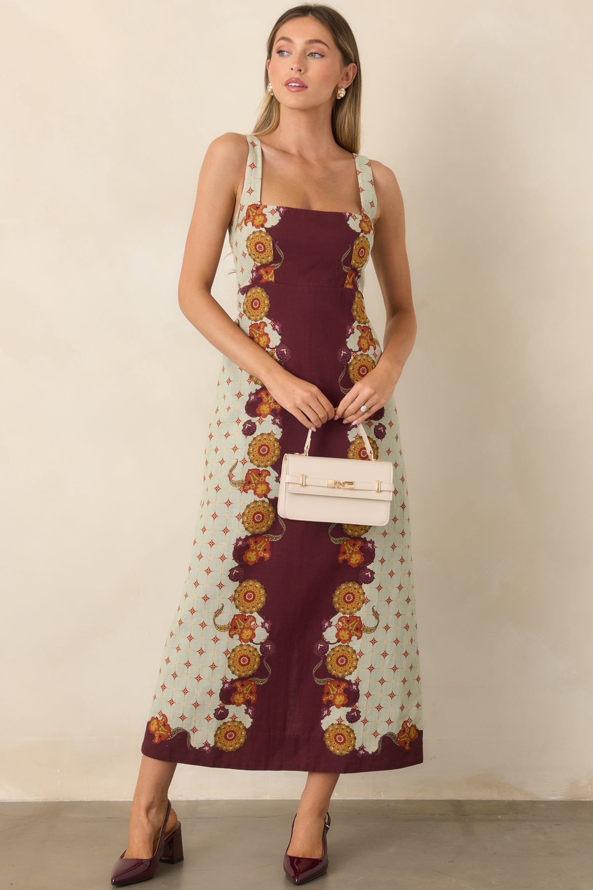 Flared midi dress showcasing mustard gold, rust, and plum blooms against a rich wine center.