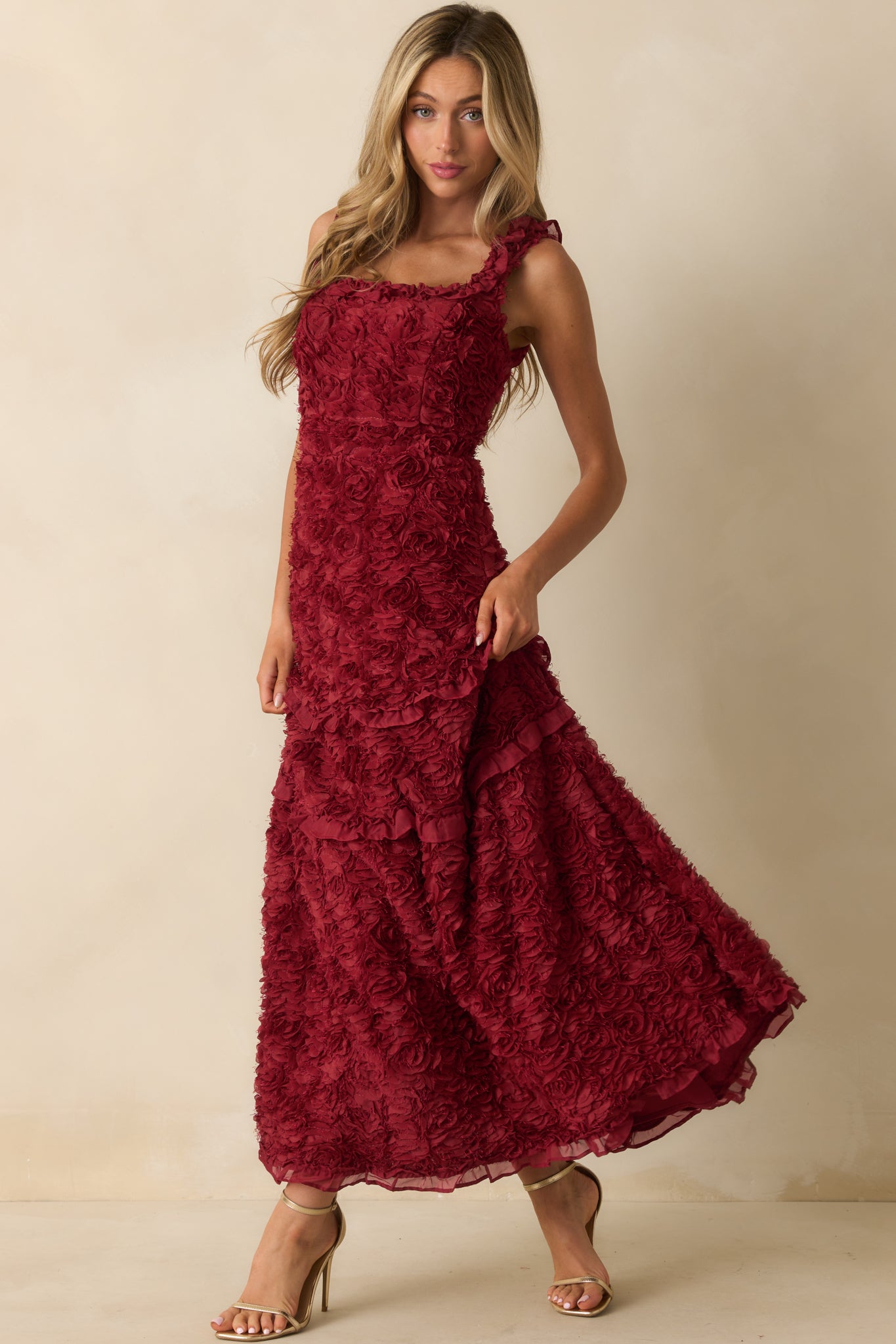Wine red dress showcasing its square neckline and flowy ruffle hemline.