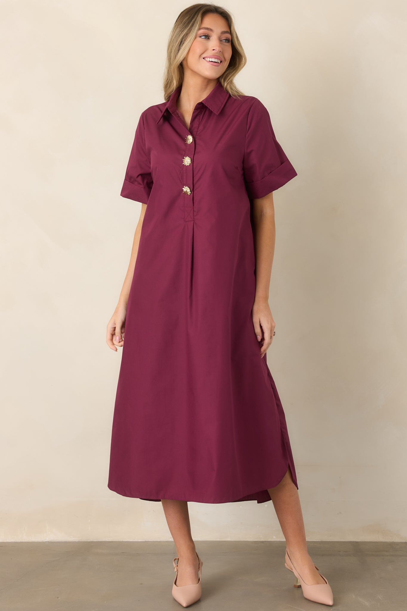 Rich wine red shirt dress showcasing its partial button-front placket, decorative gold floral buttons, relaxed A-line shape, and flowing maxi length.