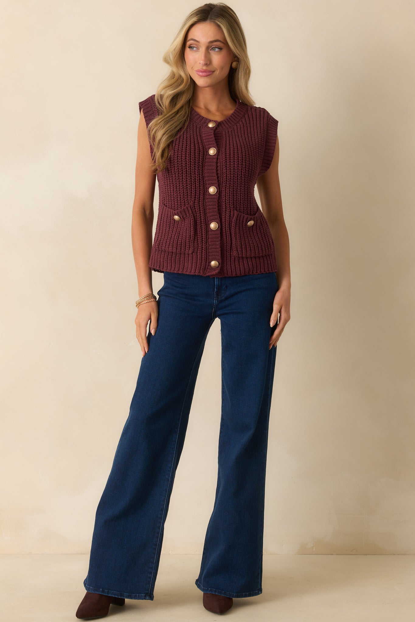 Wine red ribbed knit sweater vest with a round neckline and relaxed fit.