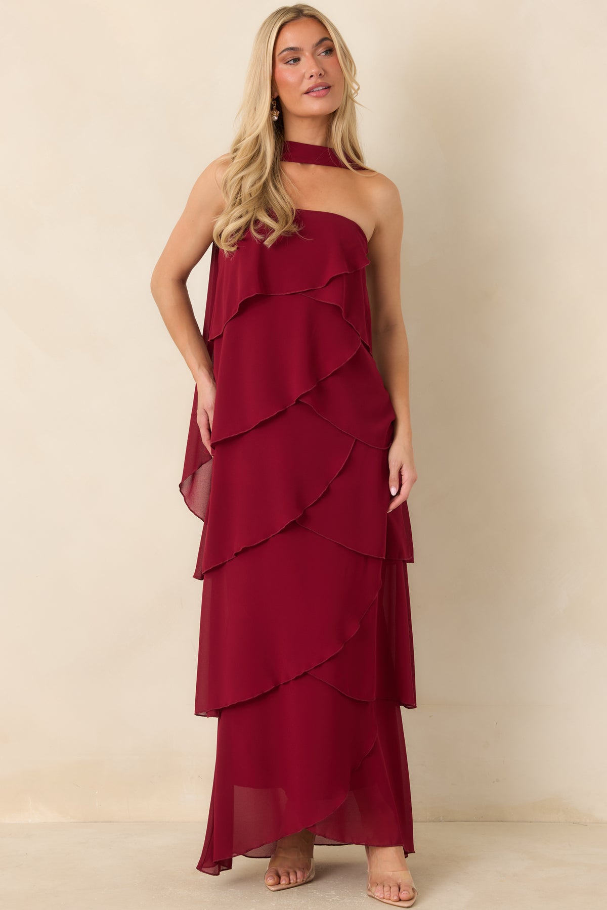 Wine red long dress featuring a strapless neckline and layered diagonal ruffle detailing.