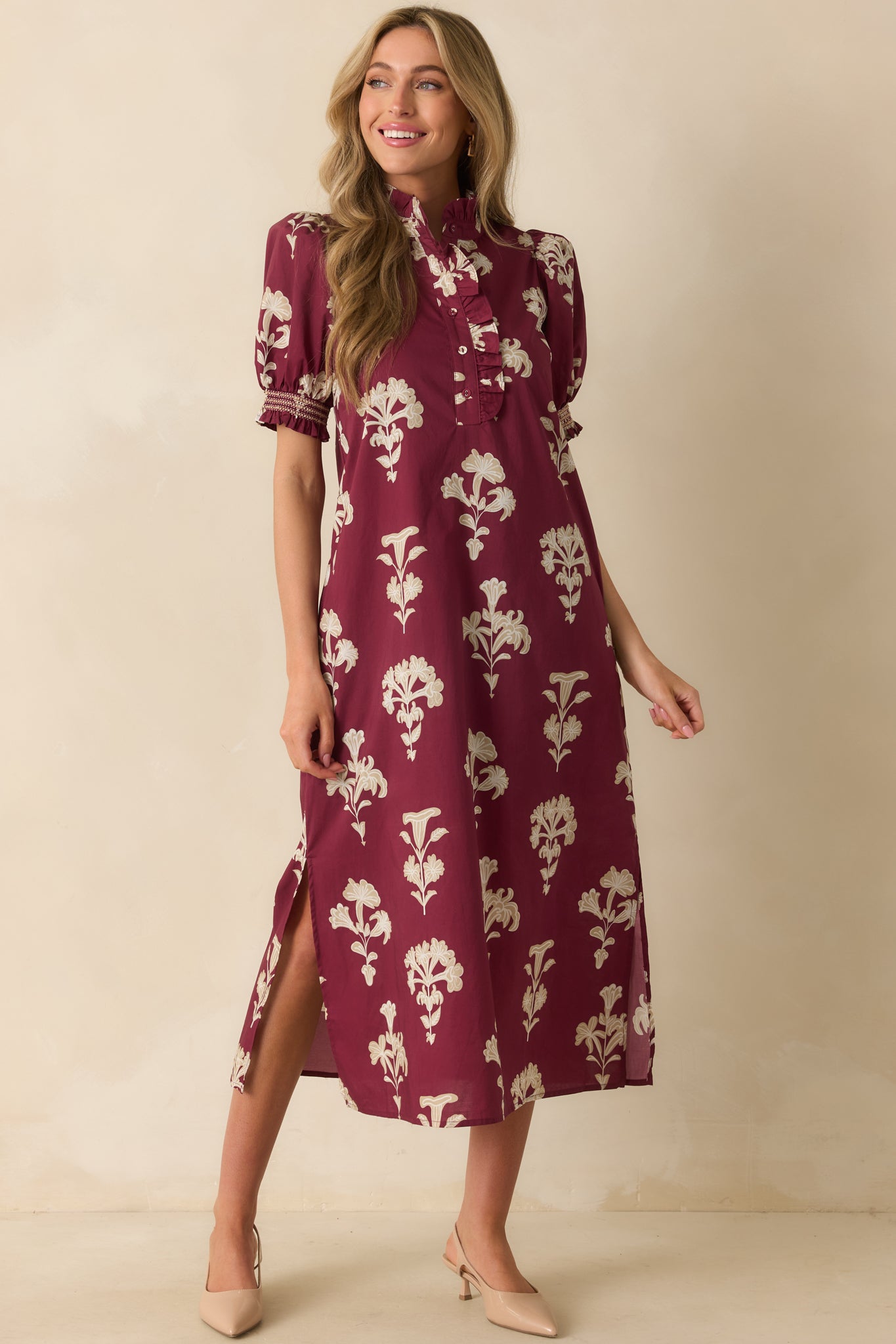 Functional pockets and short puff sleeves highlighted on the wine red maxi dress with ivory floral print.