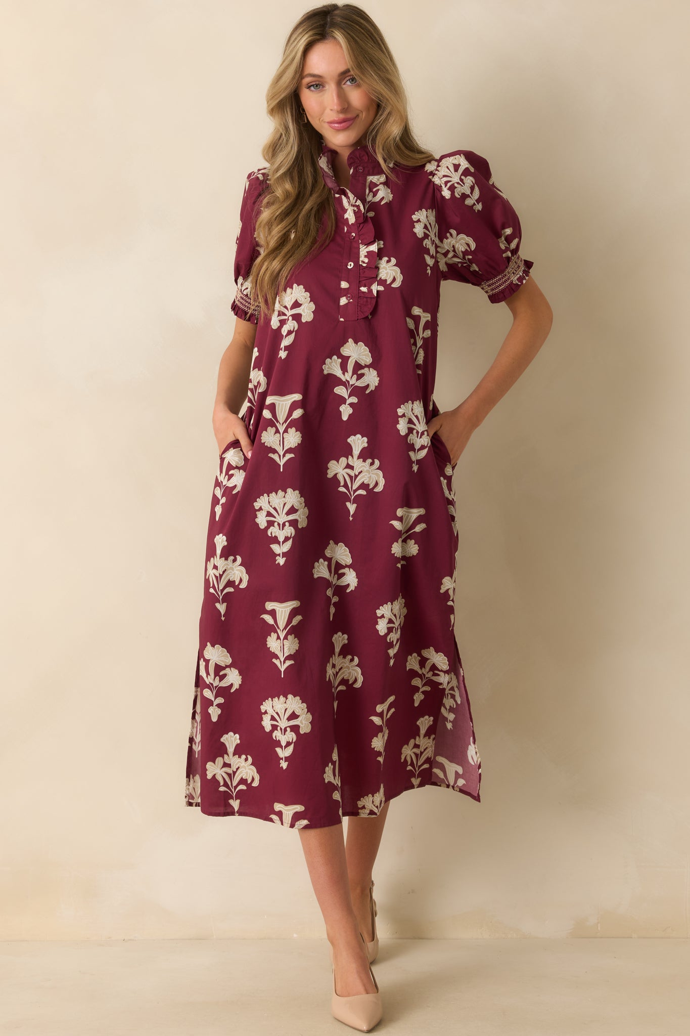 Wine red maxi dress with ruffled mock neckline, quarter button front, and breezy hemline slits.