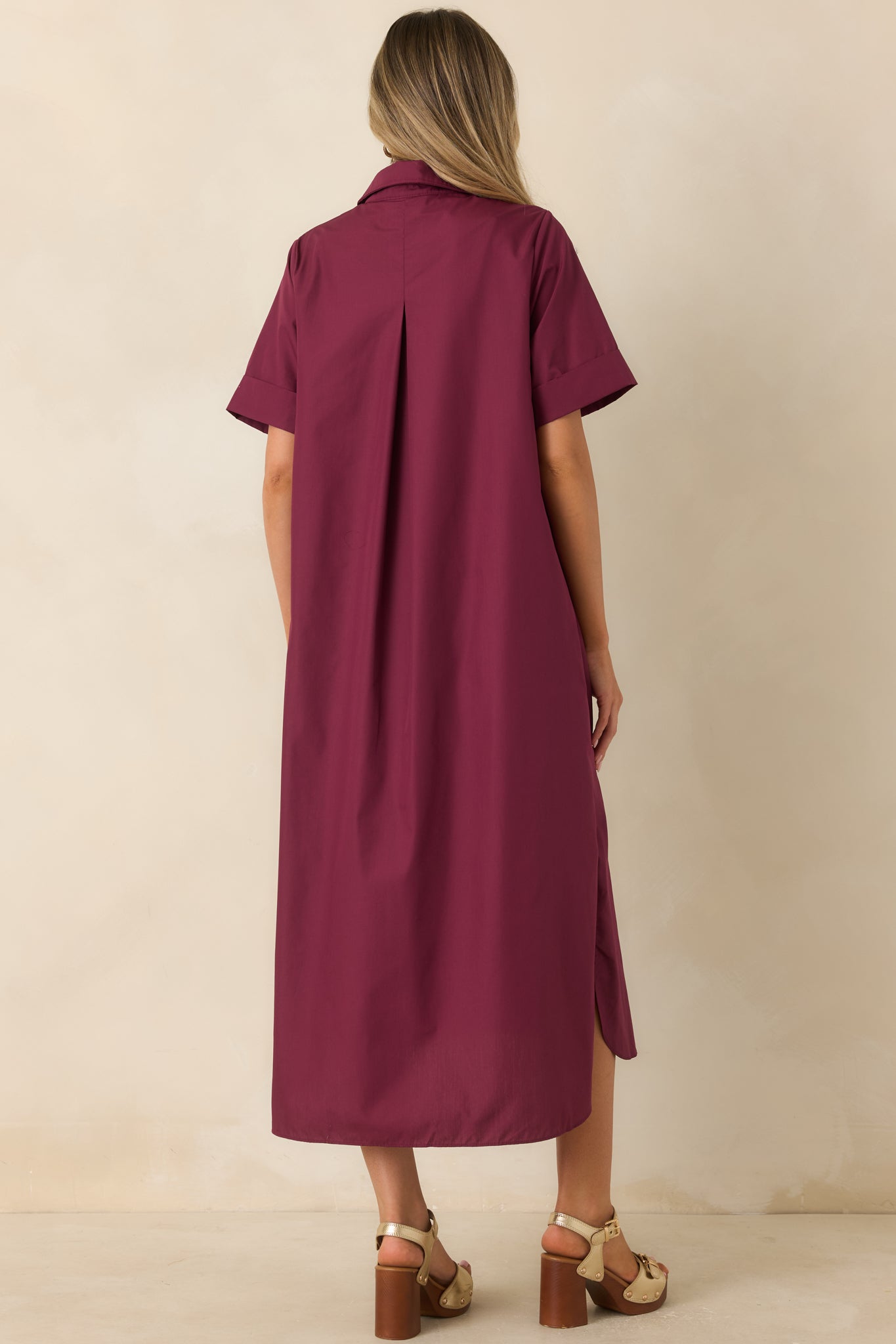 Rear view of the wine red maxi dress featuring a relaxed A-line silhouette and flowing woven fabric.