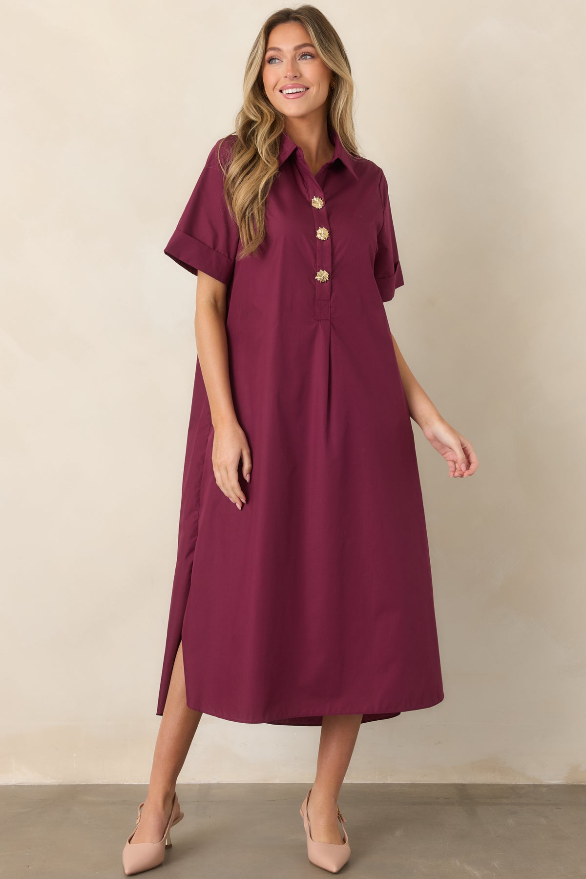 Relaxed shirt-style maxi dress showcasing the deep wine red hue, partial button placket, rolled sleeves, side pockets, and graceful flowing silhouette.