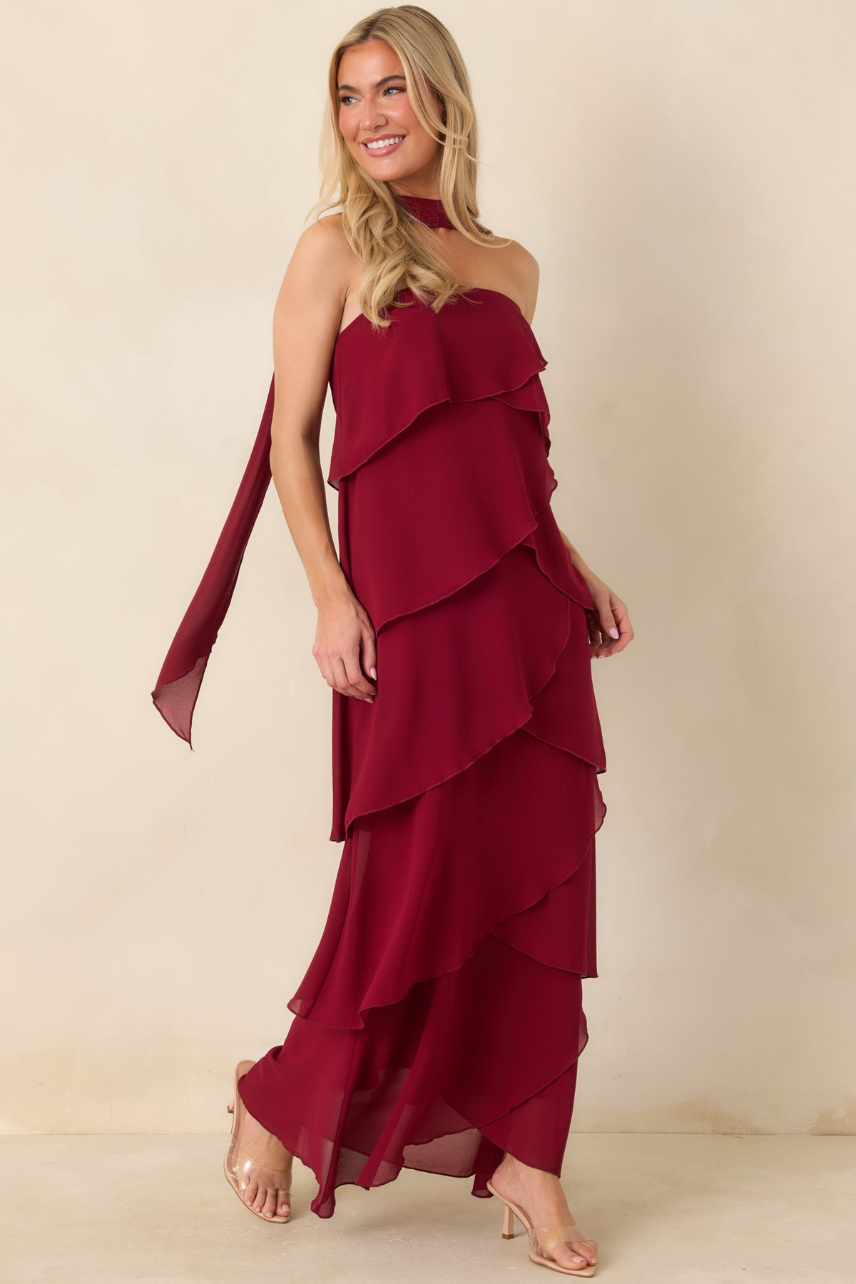 Wine red strapless dress with cascading angled ruffles flowing down the long skirt.