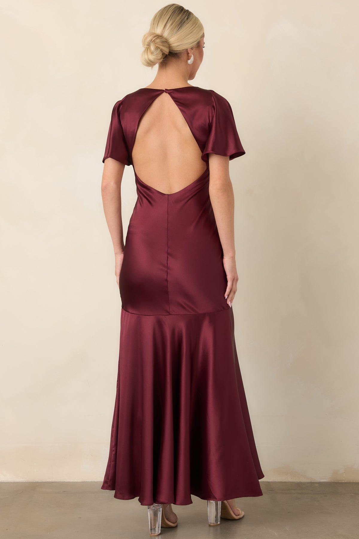 Rear of the wine satin maxi dress revealing the dramatic open back and single neck button closure.