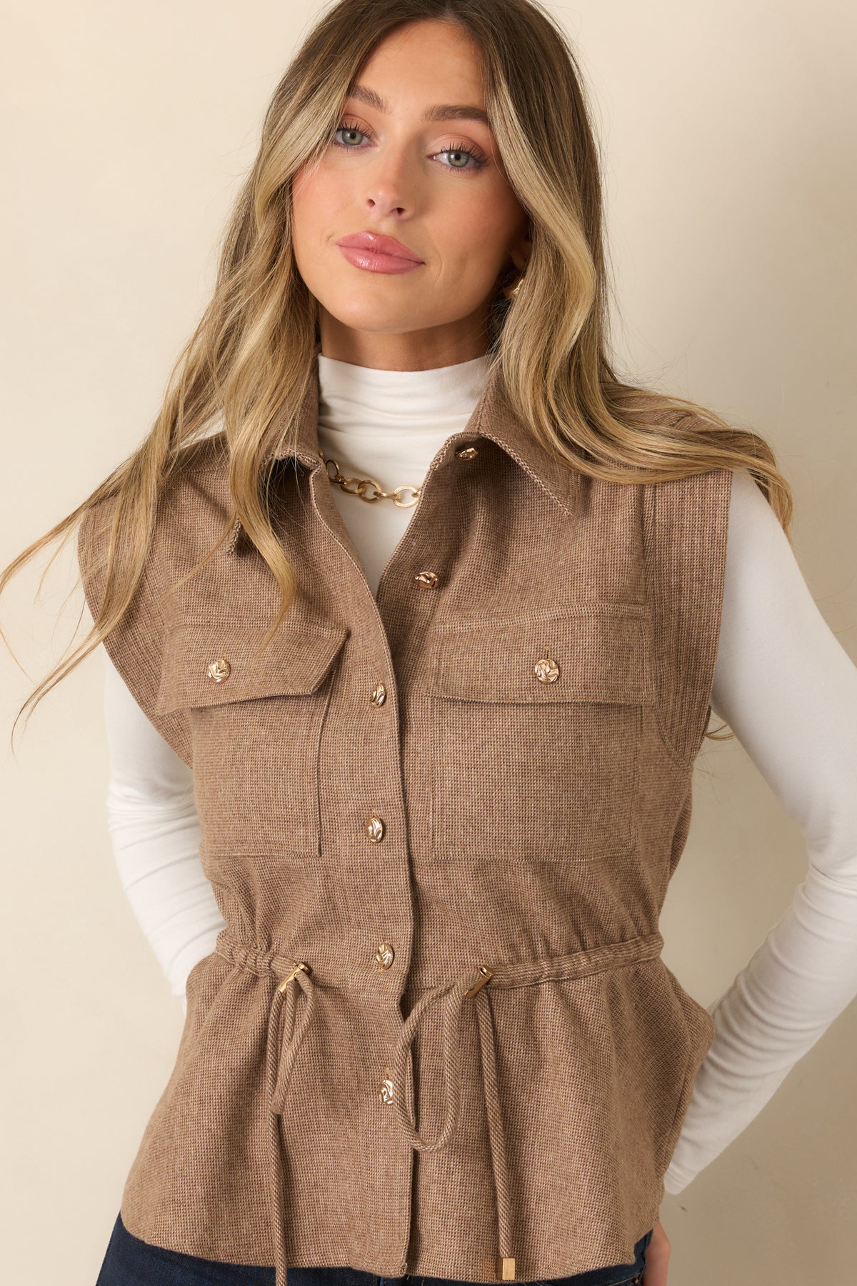 Wool-blend vest with a sculpted waist, gently flared hem, and polished gold-tone button closure.