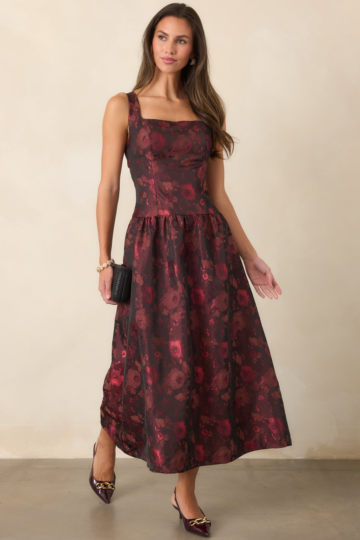 Woven floral dress showcasing the square neckline, fitted waist, and full midi-length skirt.