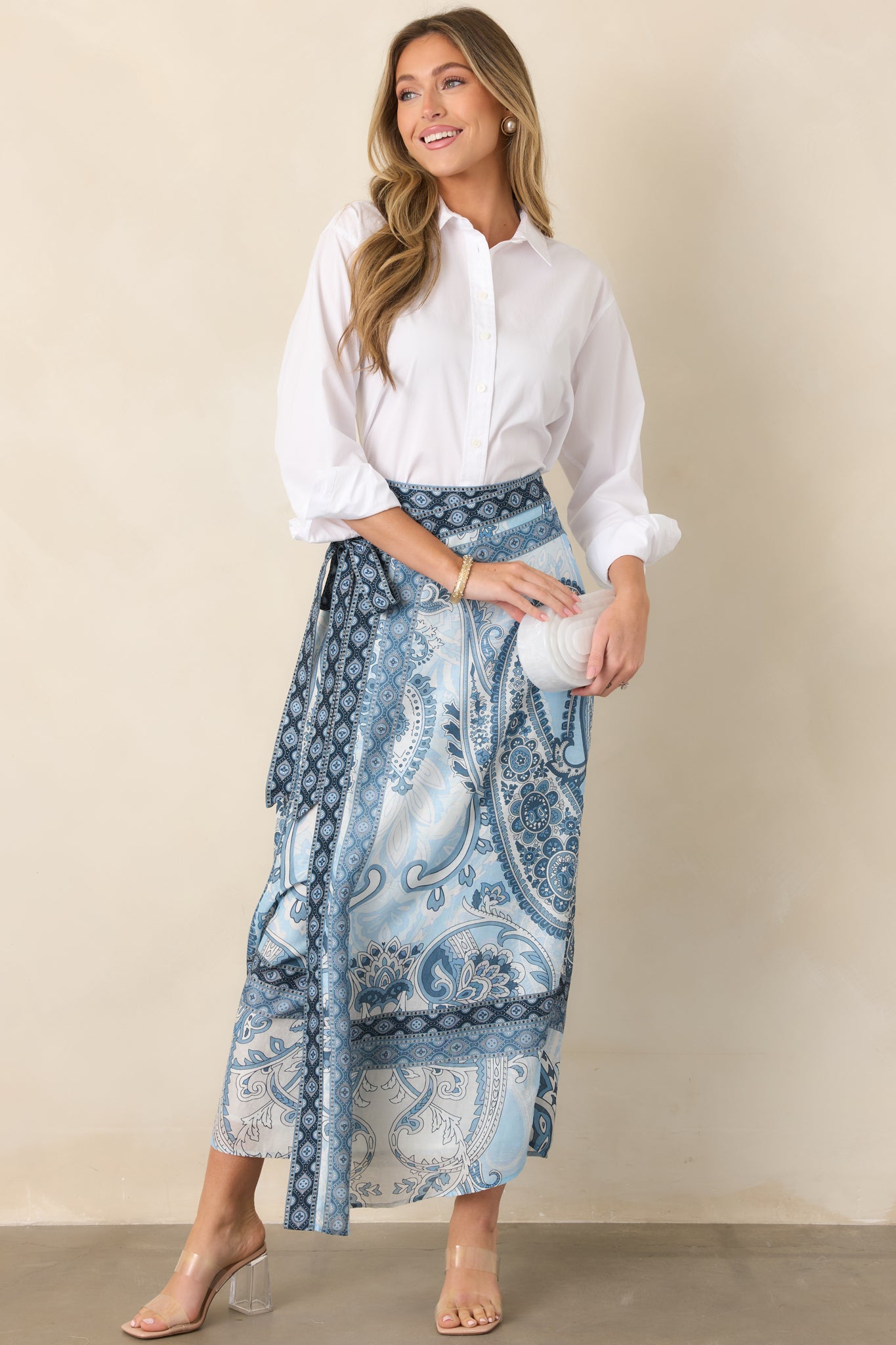 Flowing wrap maxi skirt with a self-tie waist and contrasting border print framing the hem for a polished finish.