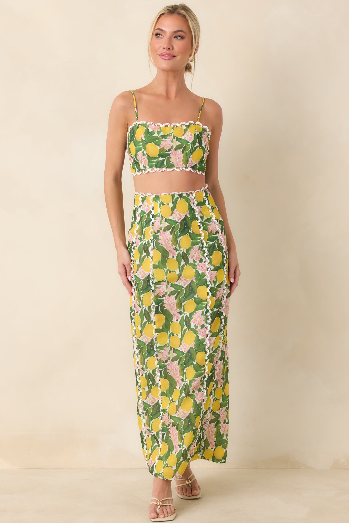 Vibrant yellow floral maxi skirt featuring decorative scalloped lace panels, a structured waist, and a flowing straight silhouette with ease of movement.