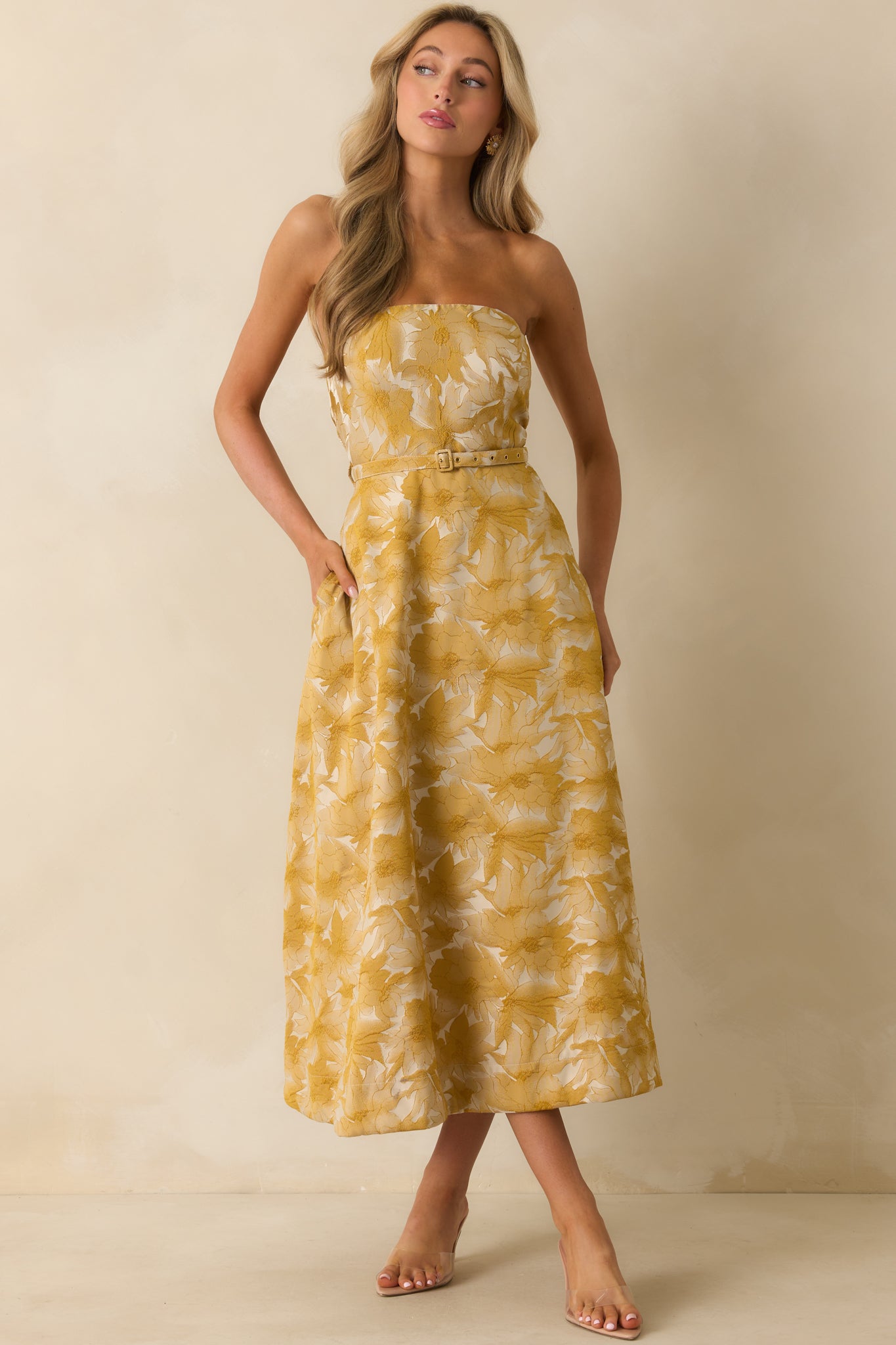 Yellow gold dress with structured bodice and subtle sheen.