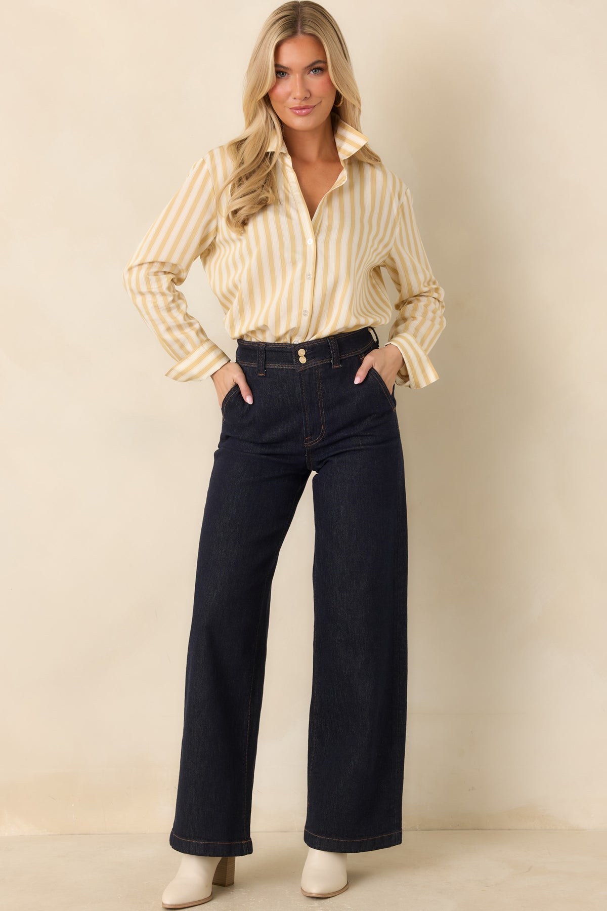 Yellow and ivory striped button-down shirt featuring long sleeves, buttoned cuffs, and a relaxed, slightly loose silhouette.