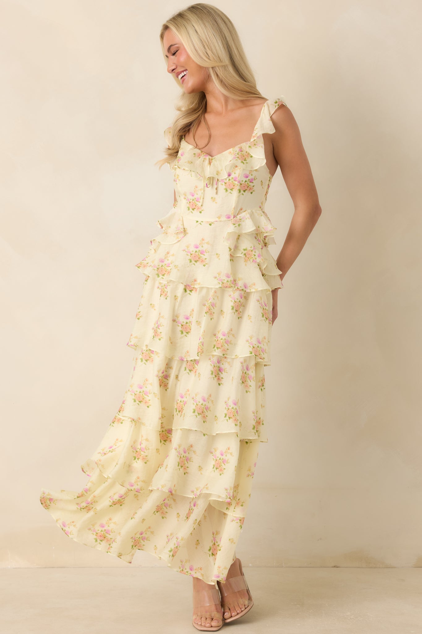 Yellow printed maxi dress highlighting ruffle-trim straps, a defined waist, and an airy layered skirt