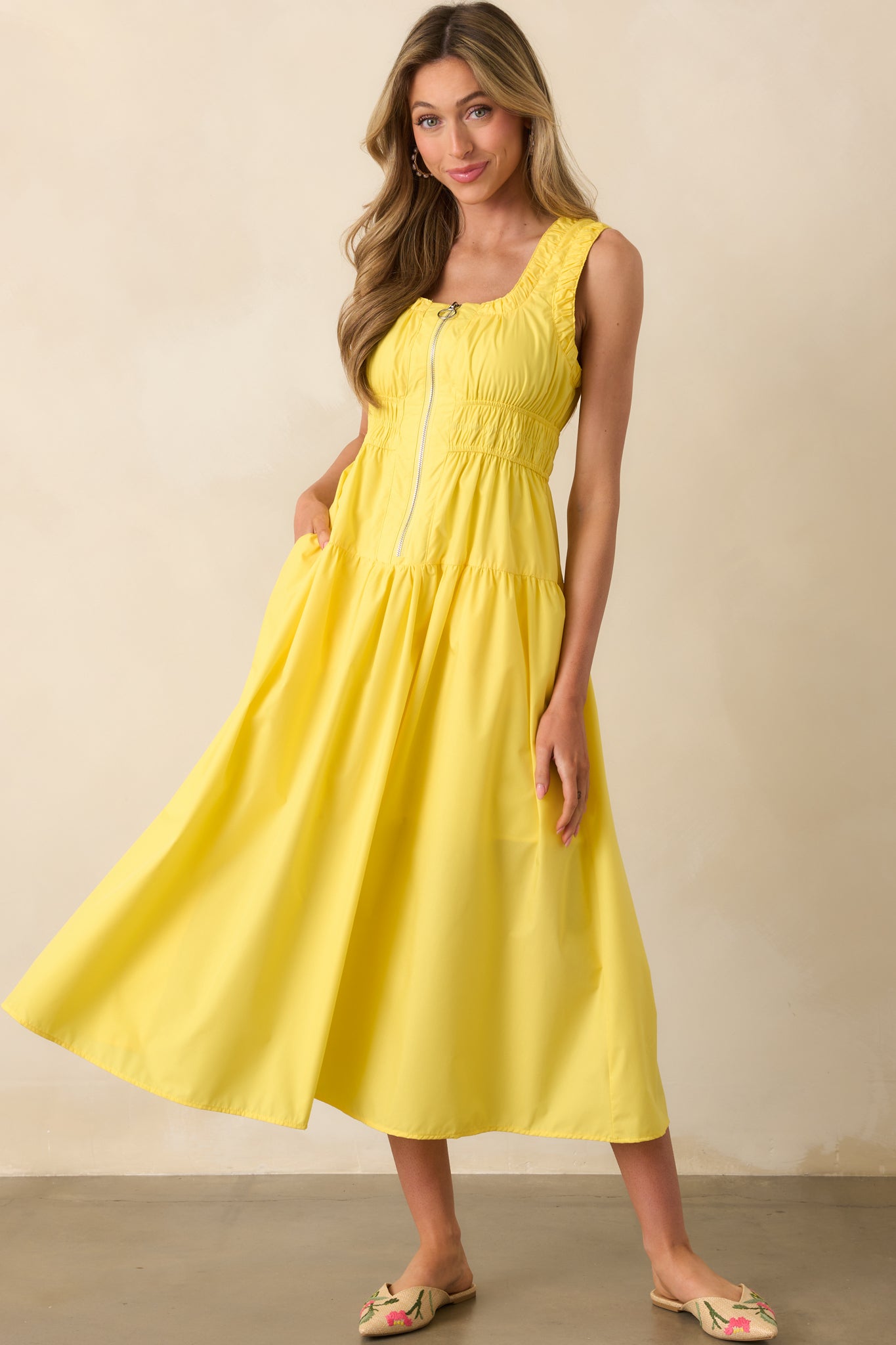 Yellow midi dress displayed frontally, emphasizing the scoop neckline, subtle trim ruching, and convenient side pockets.