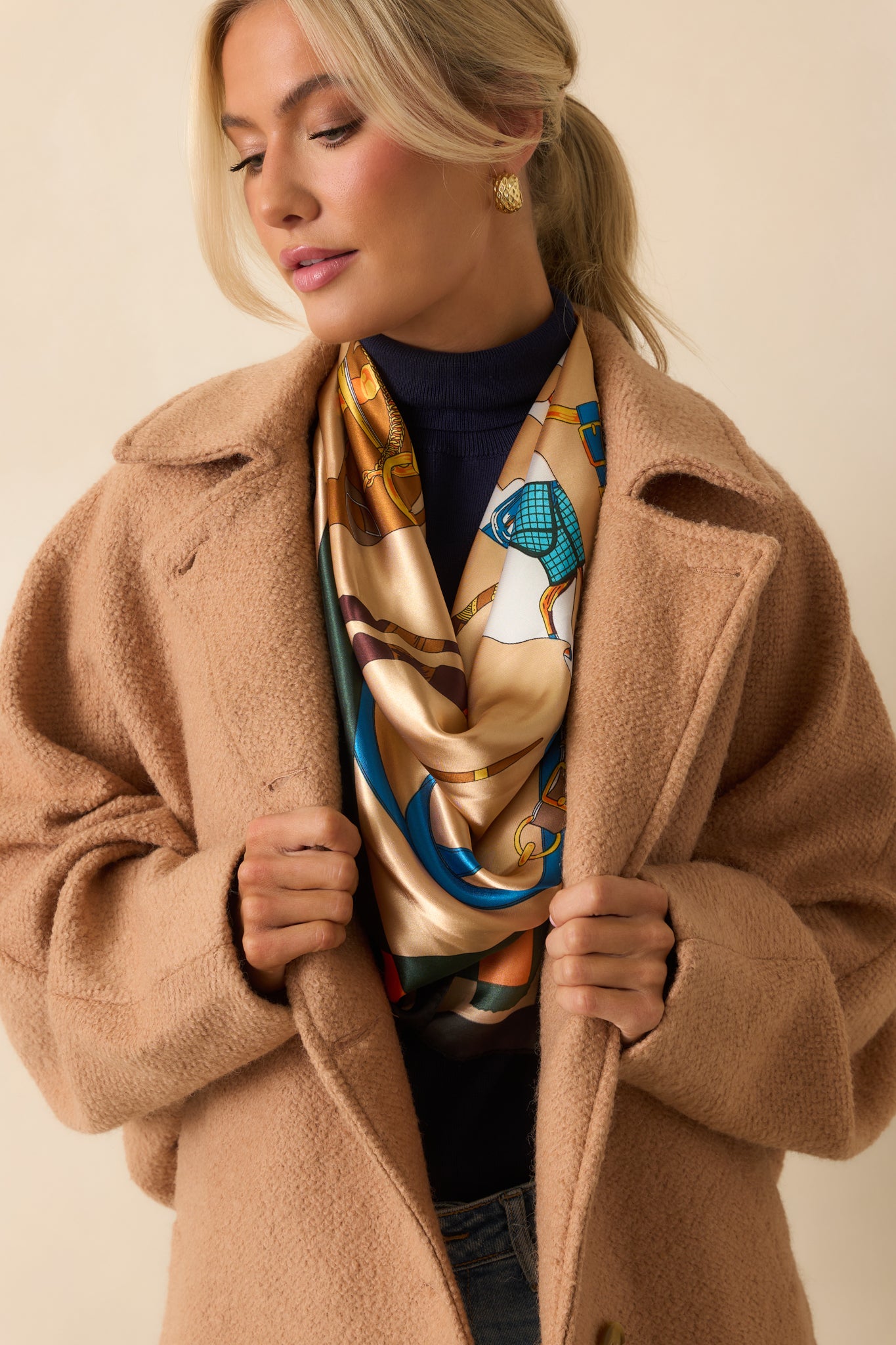 Zoomed detail of the wool-blend texture and stitching on the camel brown coat.