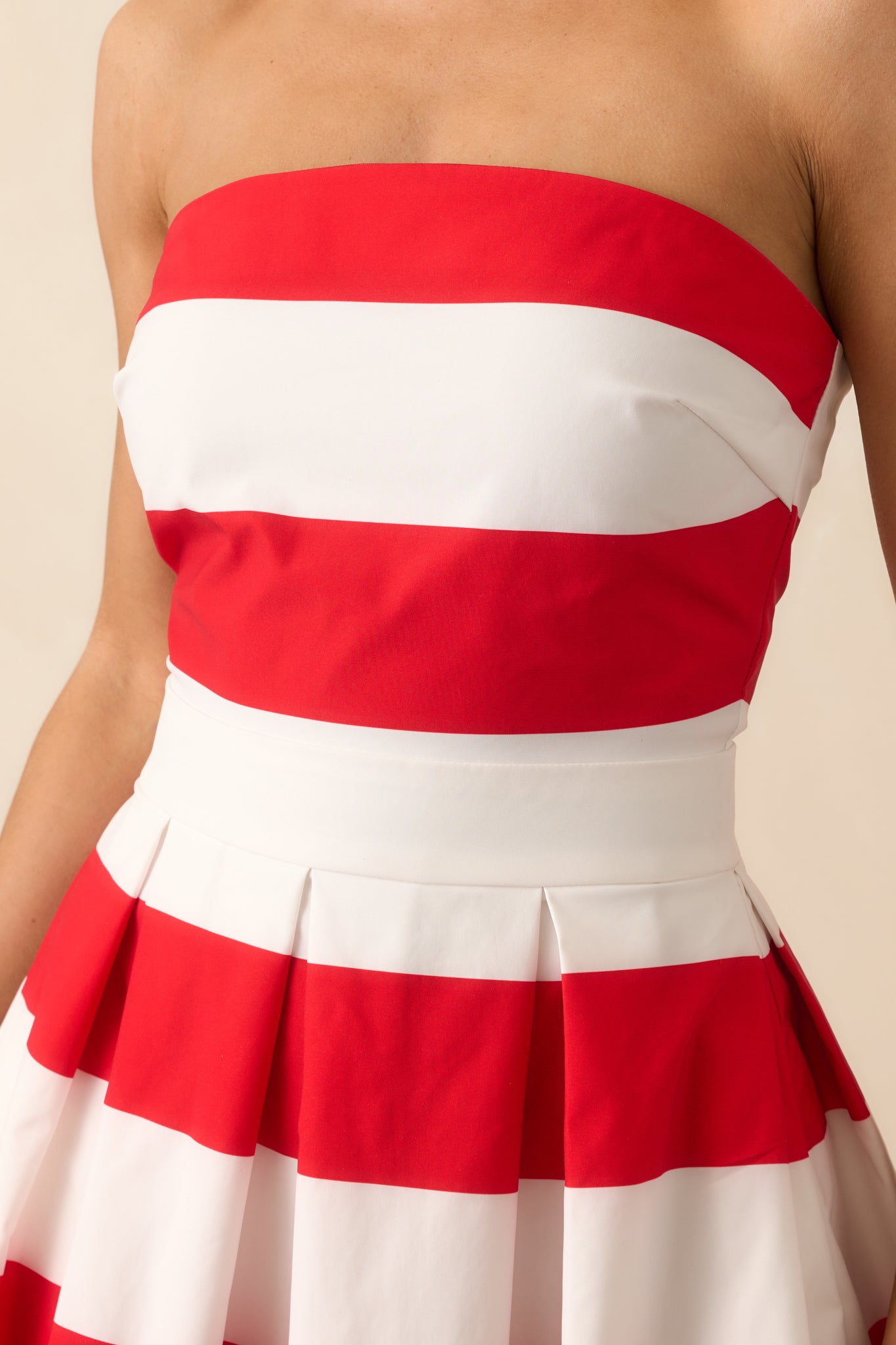 A zoomed-in shot of the bodice showing the horizontal red and white stripe pattern and the precise seamwork along the top edge.