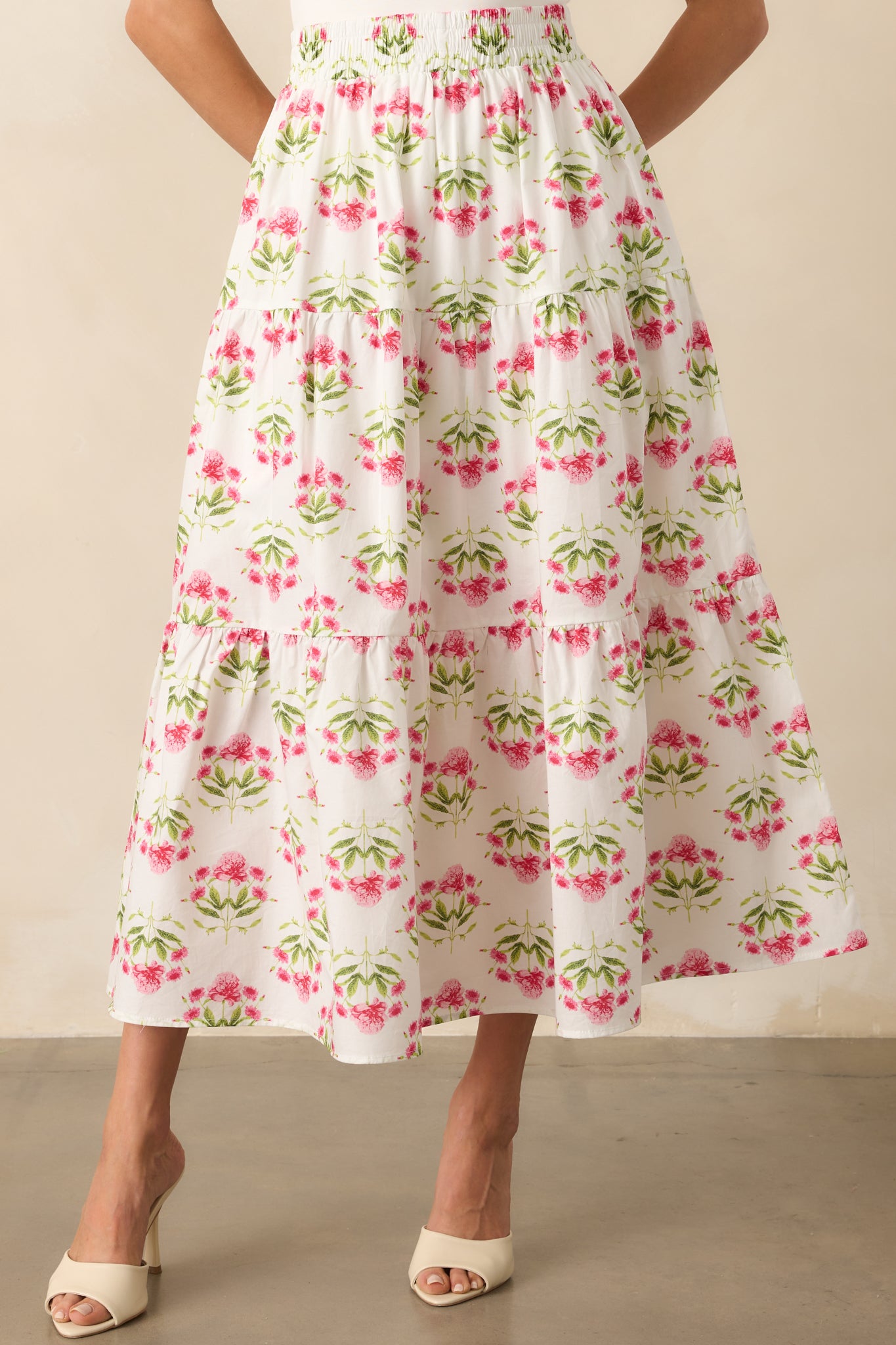 Zoomed-in view of the smocked waistband on the floral maxi skirt, showing stretch detail and texture.