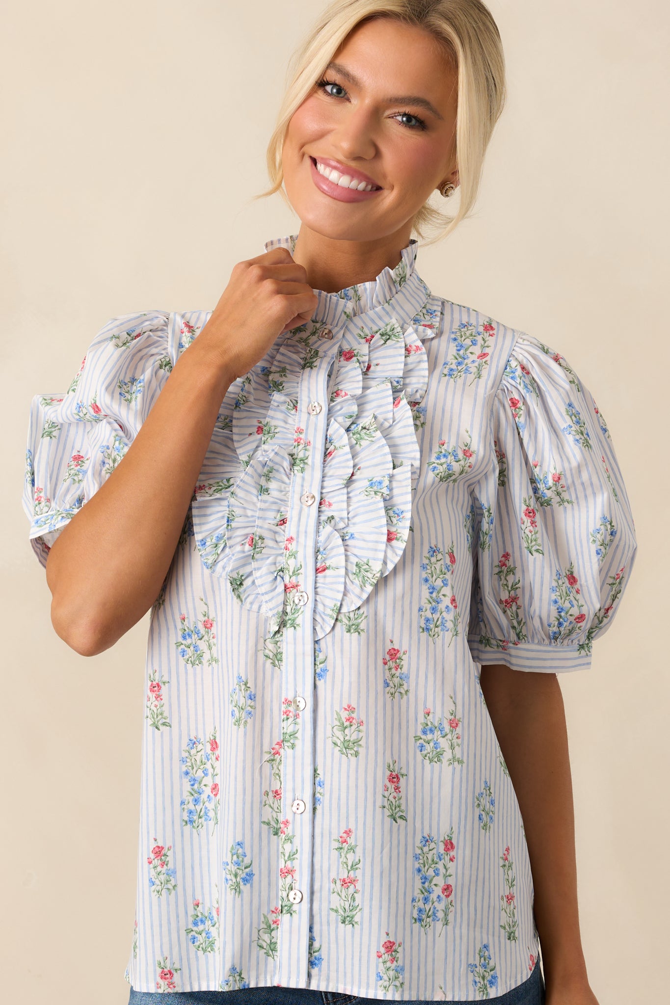 Zoomed-in view of the upper portion of the top focusing on the high ruffle neckline and start of the frill accents.